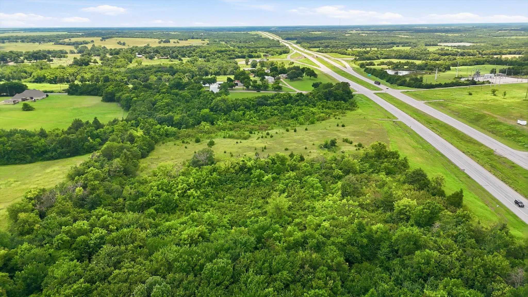Expansive acreage featuring mature trees and open green spaces
