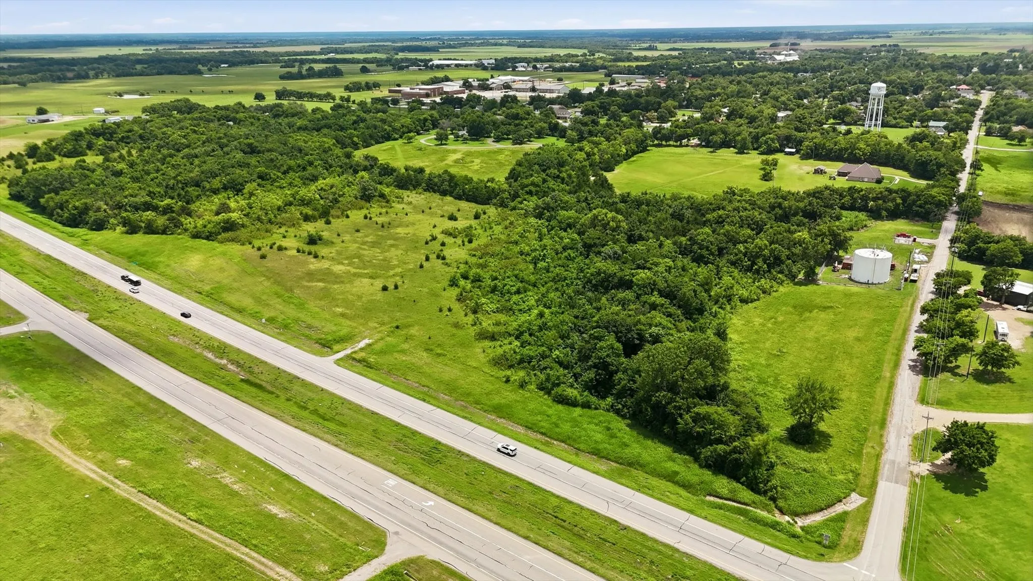 Expansive rural acreage featuring significant tree coverage and open grassy areas