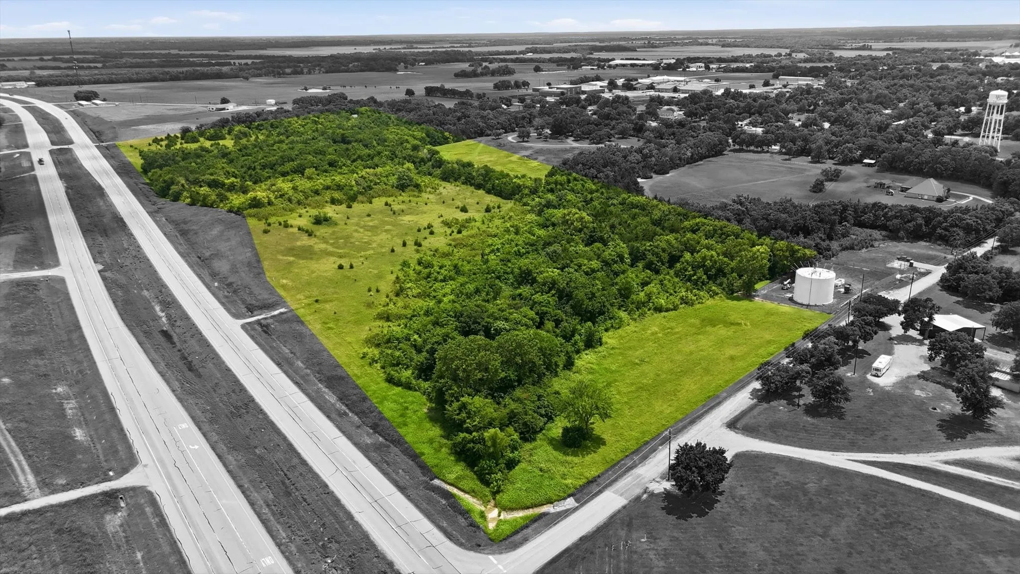 Expansive undeveloped parcel featuring a blend of wooded areas and cleared land