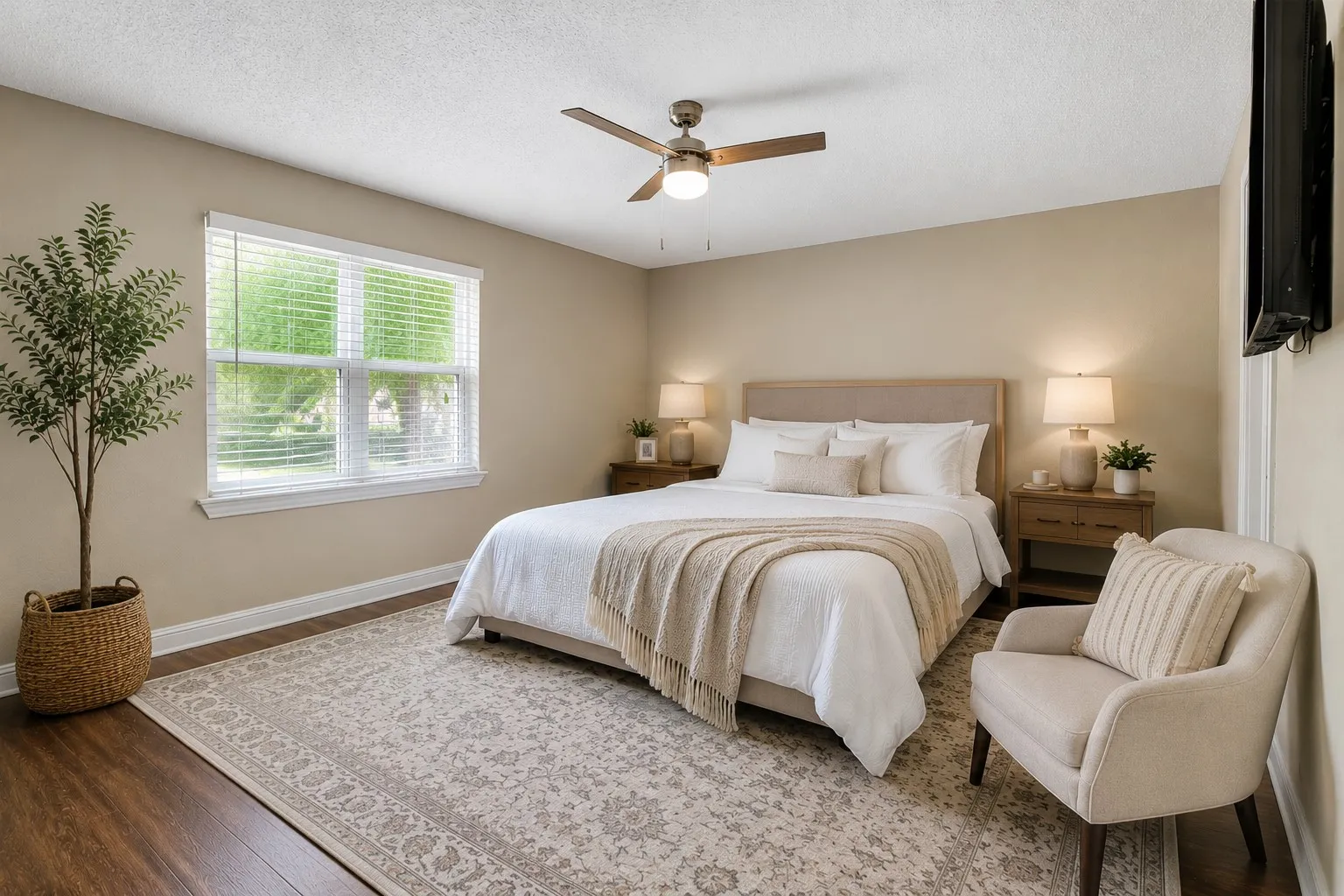 Bedroom featuring woodlike-finish flooring and a light-colored area rug