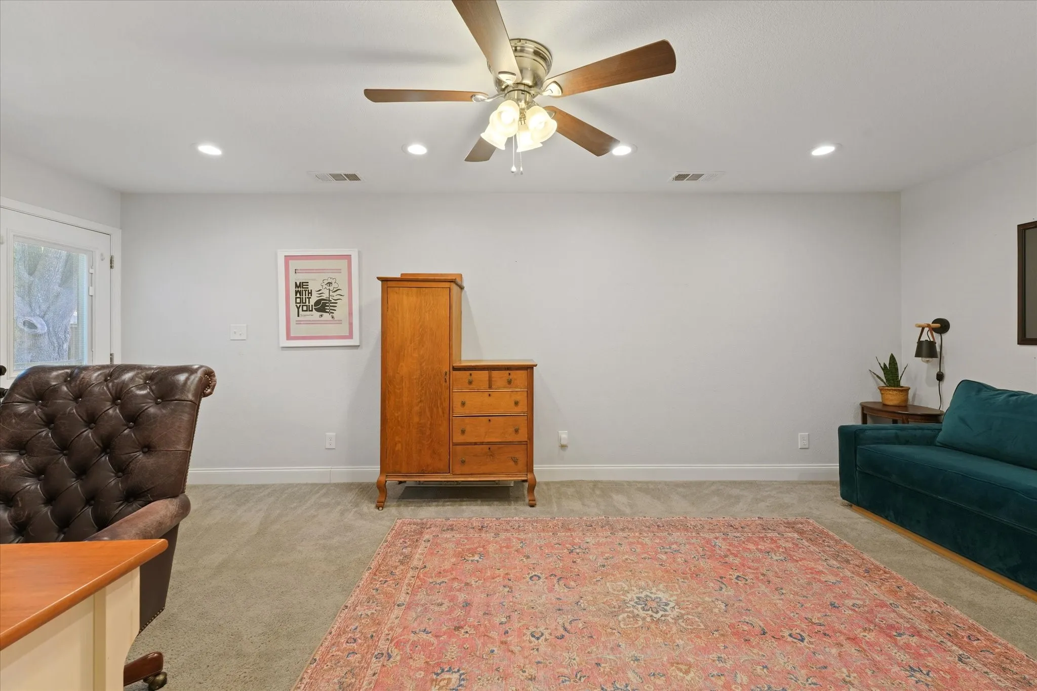 Oversized flex room ideal for a home office, media room, playroom, guest suite, or second living area with recessed lighting and private exterior access.