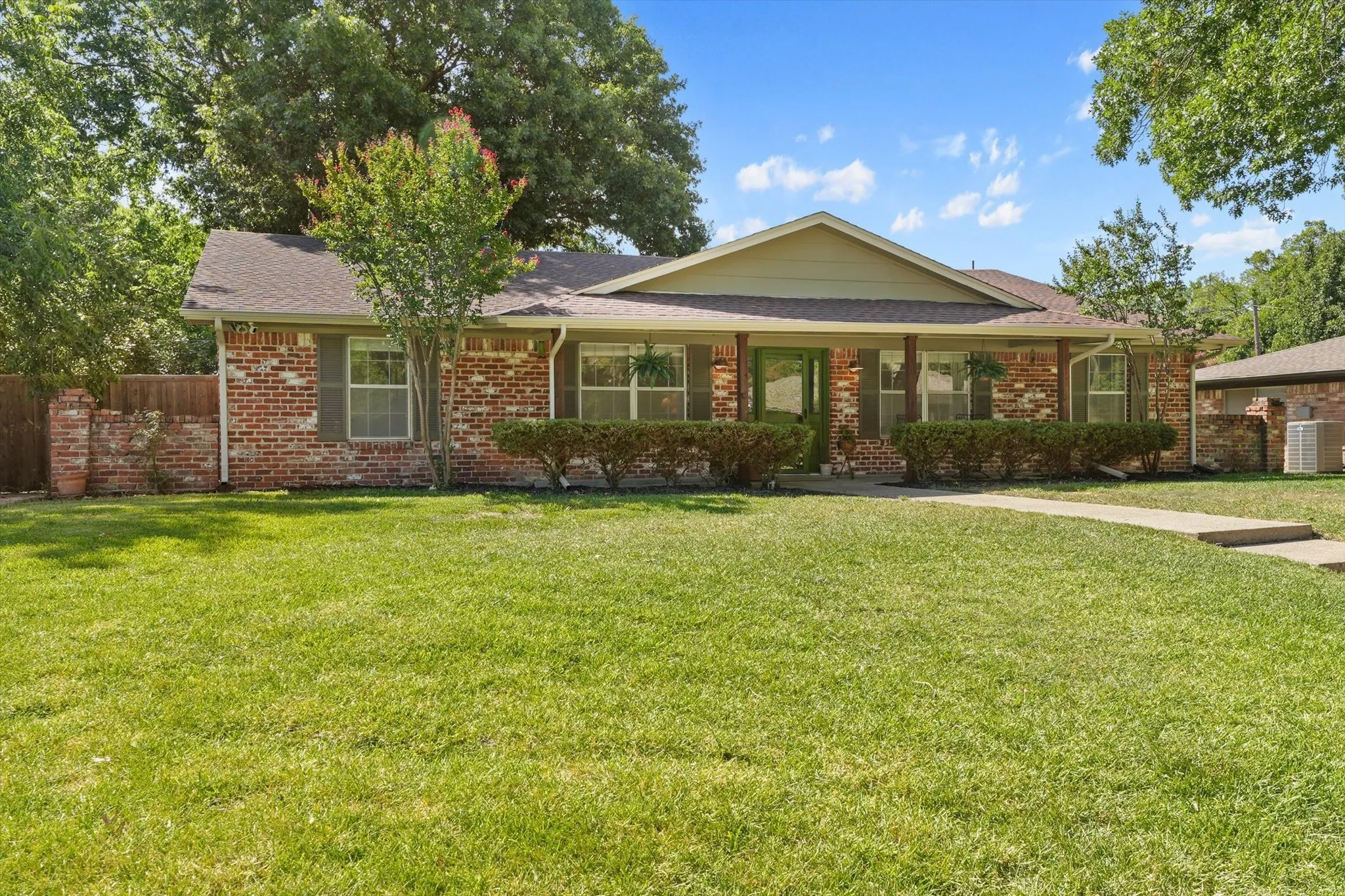 Large front lawn and inviting covered porch create a welcoming first impression just minutes from Avondale Park, Nette Shultz Park, and downtown Denton.