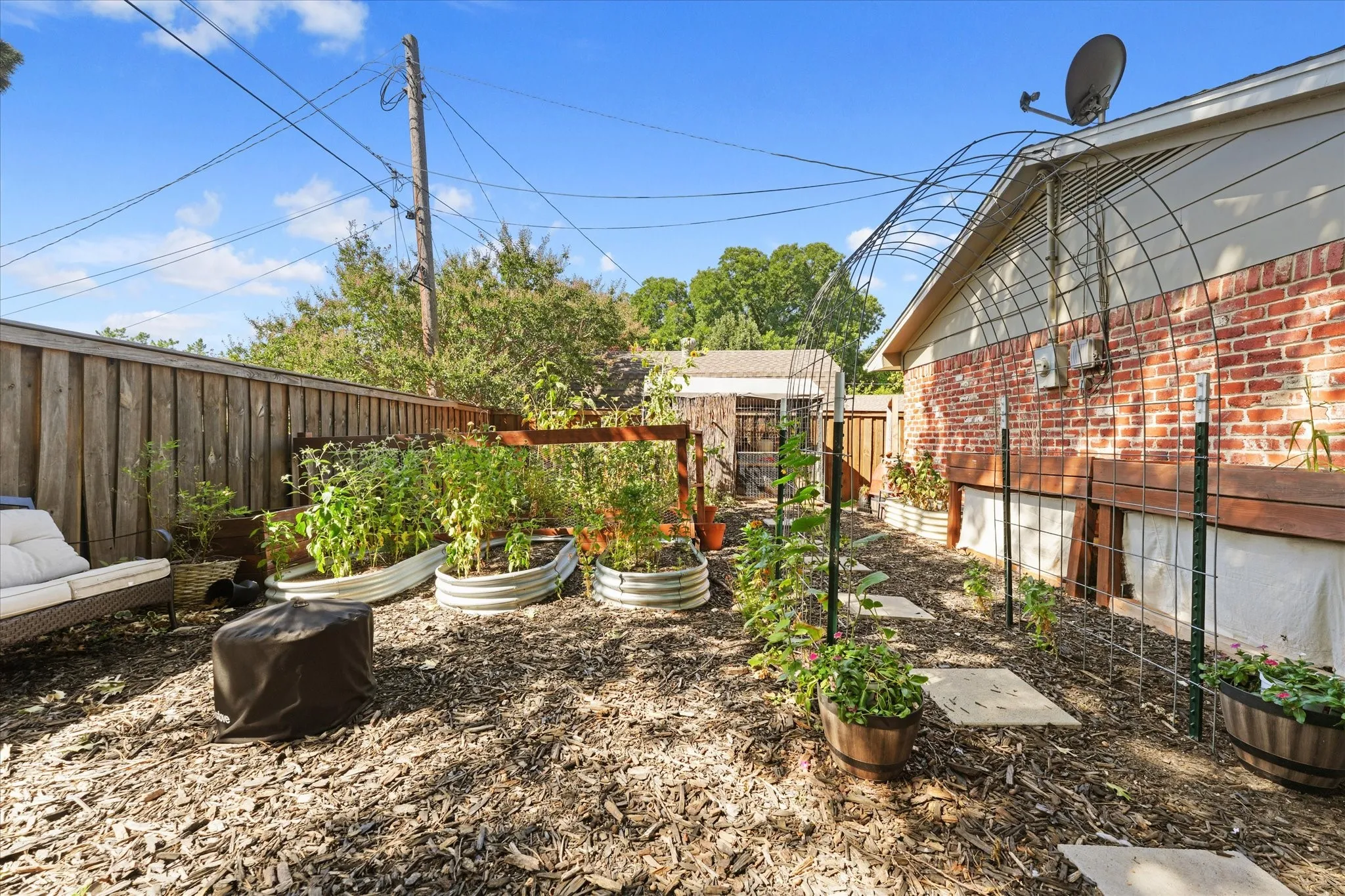 Dedicated garden area with raised beds, trellises, and space for growing vegetables, herbs, and flowers—perfect for gardening enthusiasts.