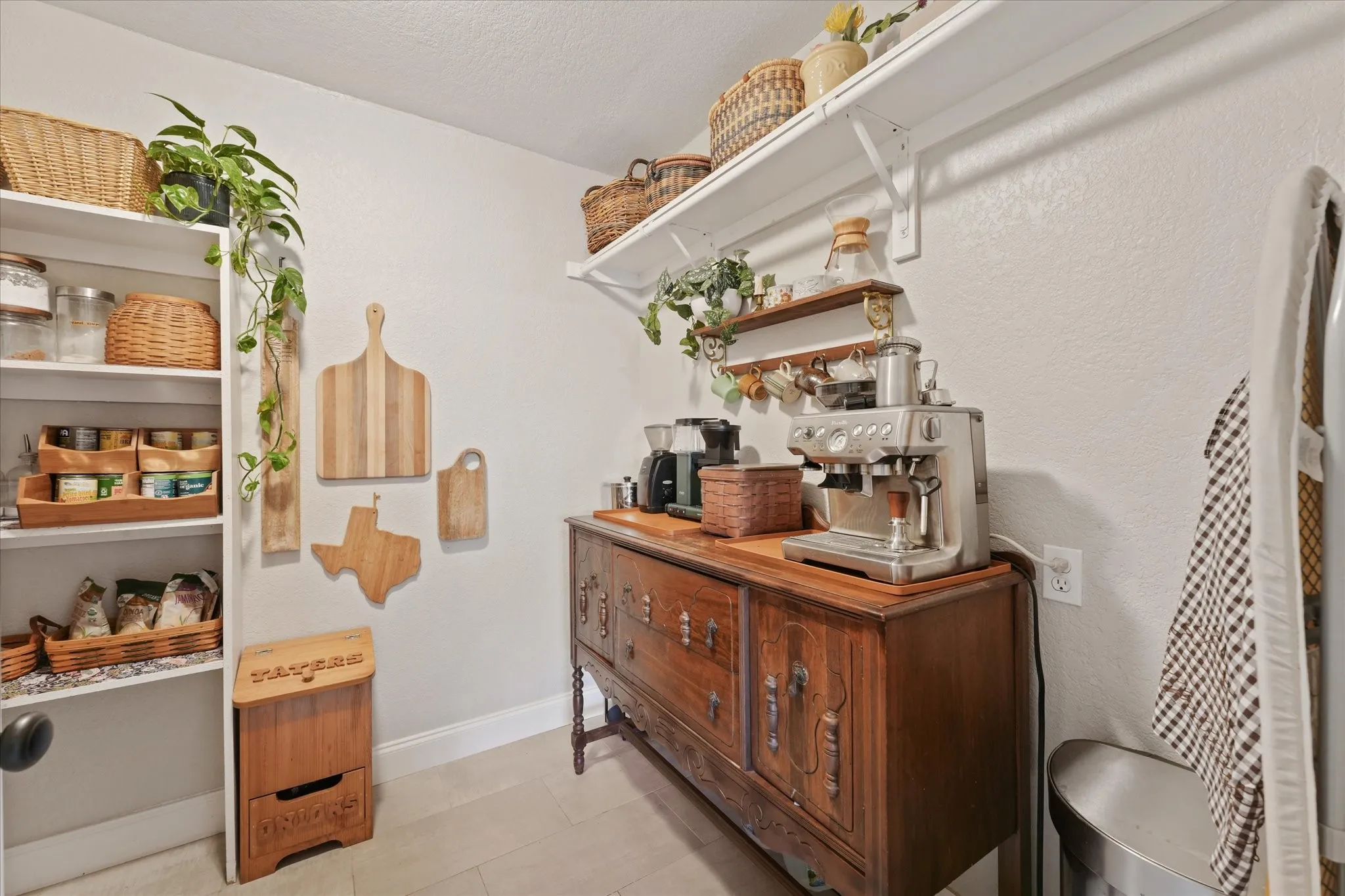 Large walk-in pantry with built-in shelving, extensive storage space, and room for small appliances and kitchen organization.