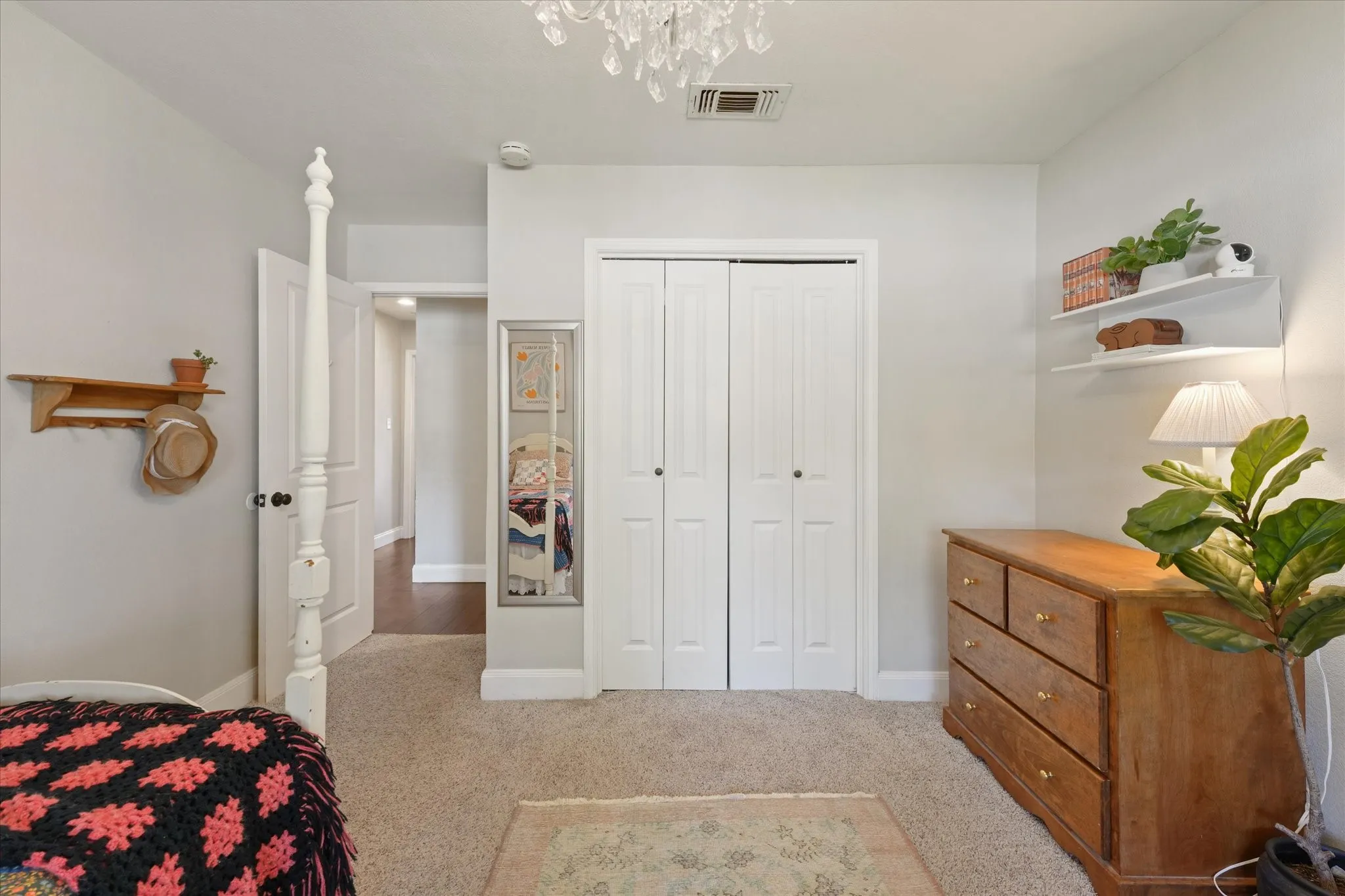 Bright secondary bedroom with spacious closet, neutral finishes, and comfortable layout overlooking the front yard.