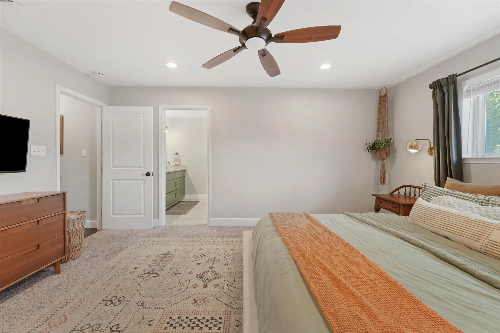 Additional view of the oversized primary suite featuring an ensuite bathroom, neutral finishes, and generous wall space for flexible furniture placement.