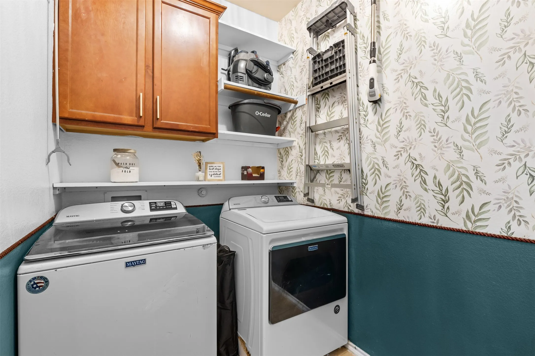 Laundry room with cabinetry and storage