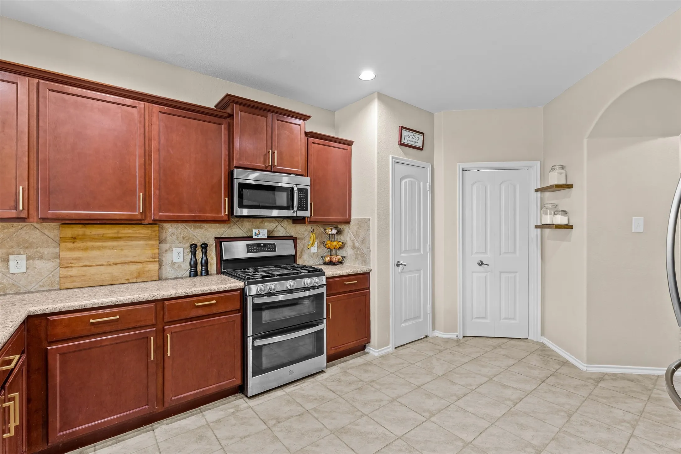 Large kitchen with stainless appliances and walk-in pantry