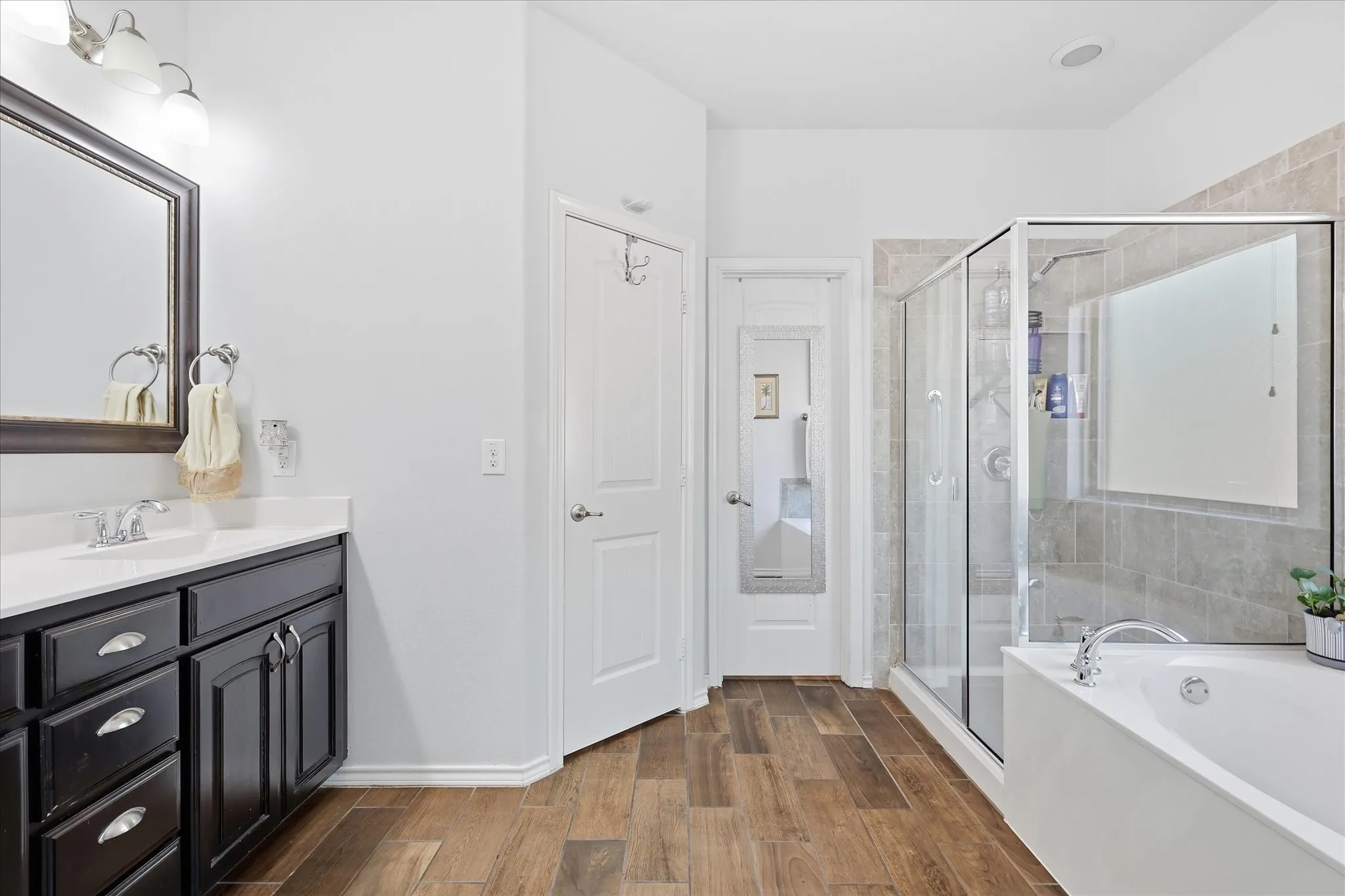 Primary bathroom with separate W.C., separate shower and tub and large walk-in closet