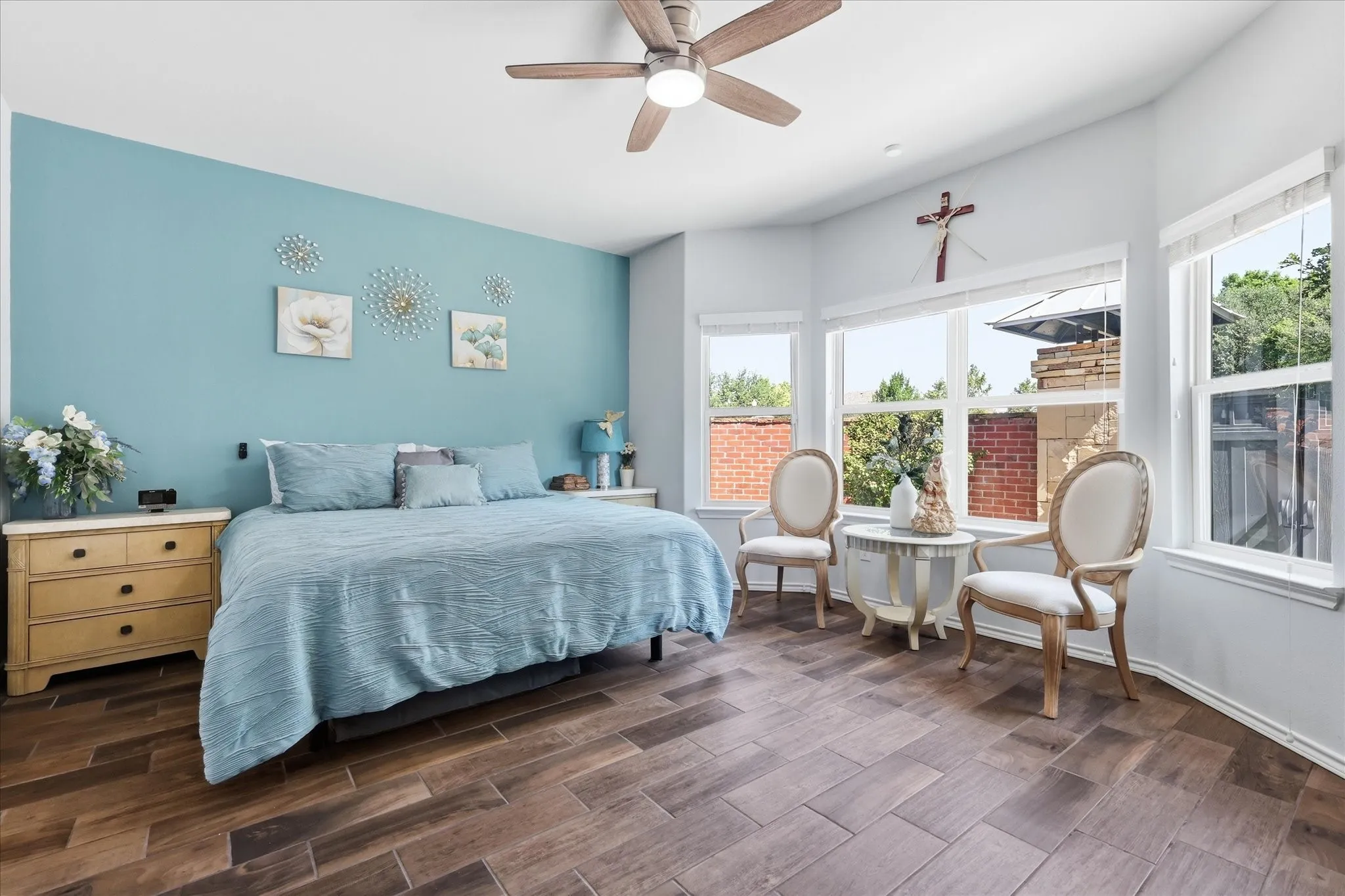 Primary bedroom - upgraded wood like tile - upgraded ceiling fan - lots of natural light