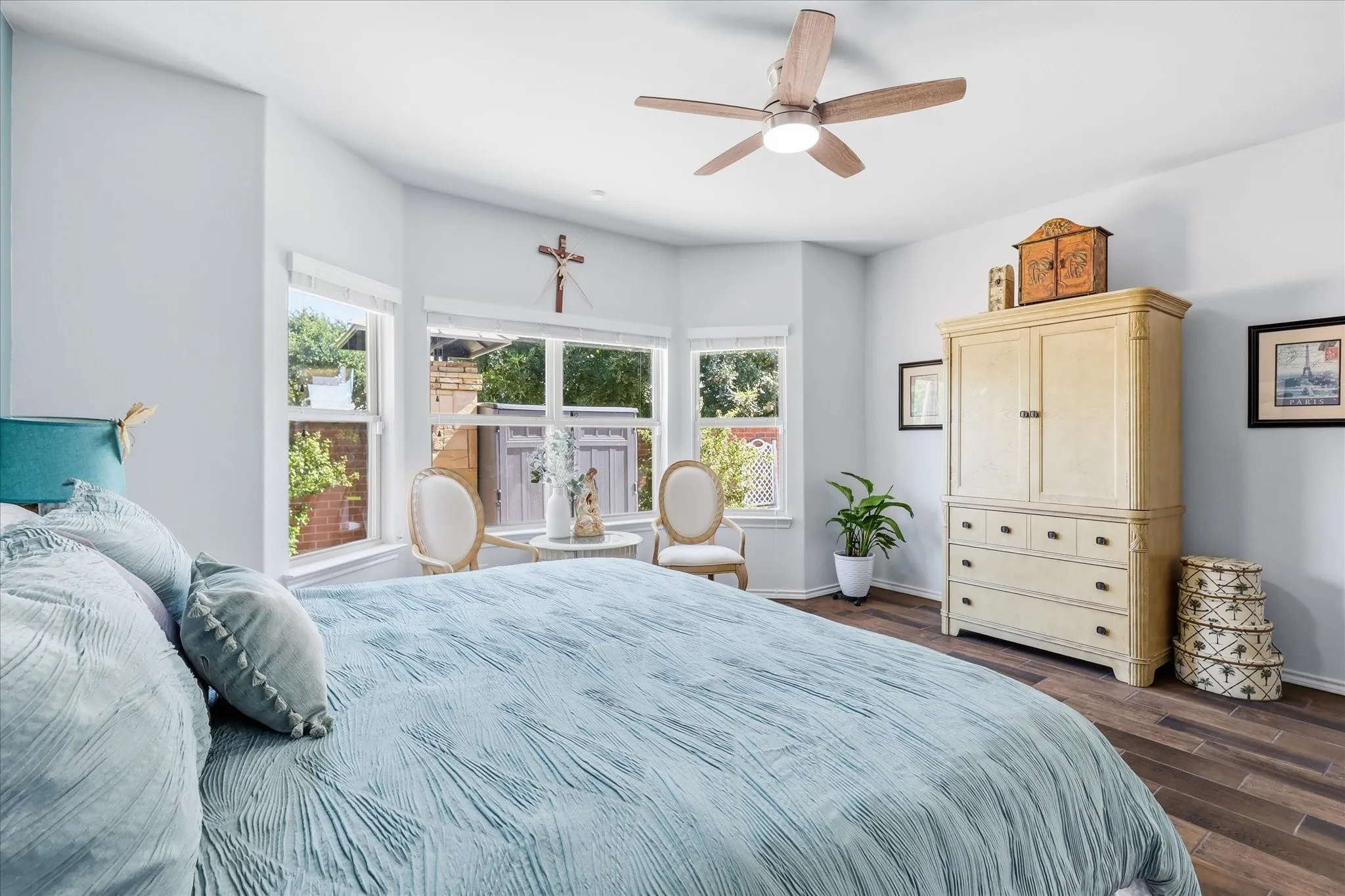 Primary bedroom - upgraded wood like tile - upgraded ceiling fan - lots of natural light