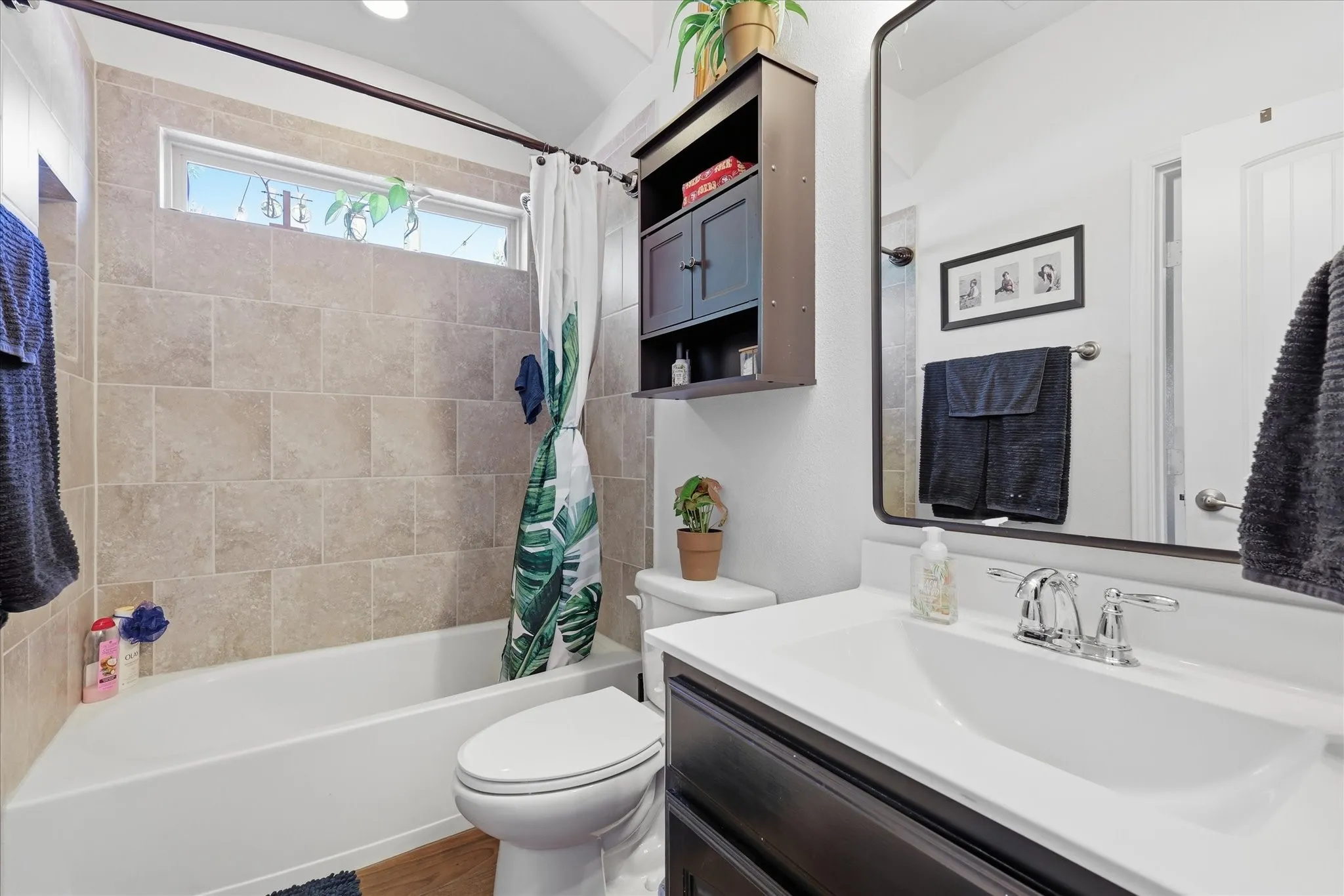 Guest Bathroom with wood look tile and upgraded mirror