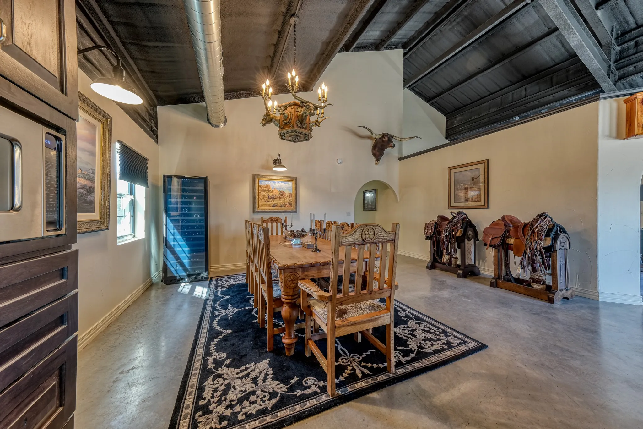 Expansive interior space featuring a dark wood-paneled ceiling, exposed ductwork, and light-toned walls