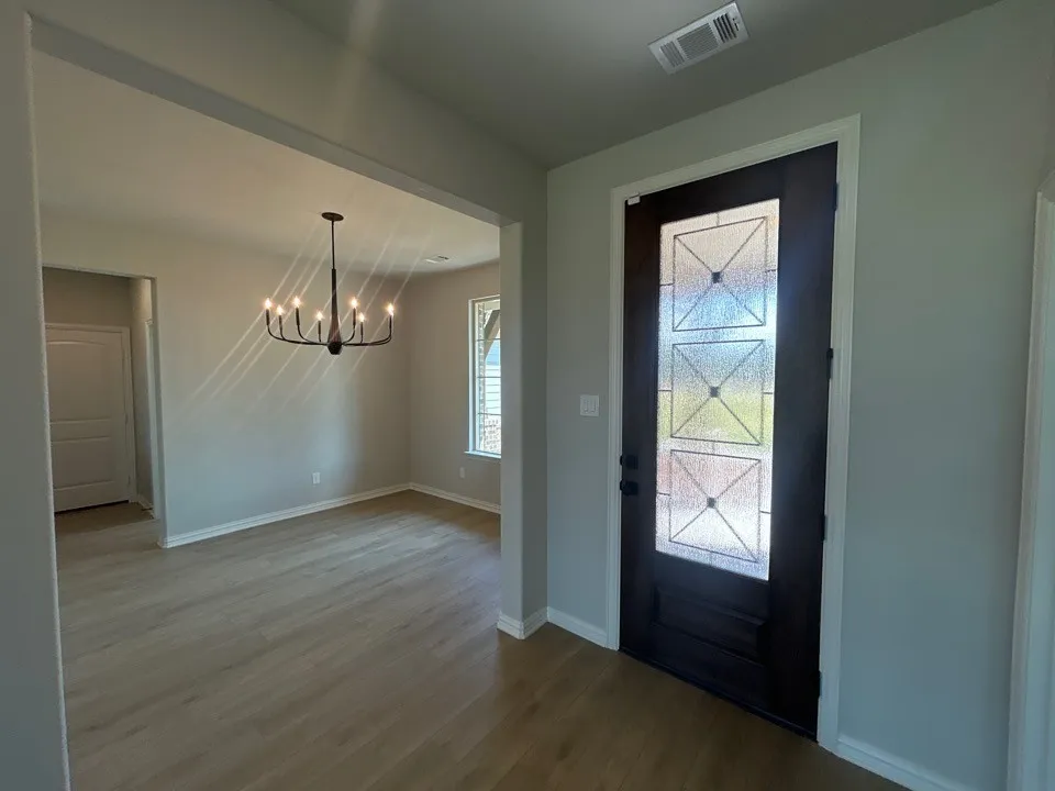 Dark wood-finish entry door with decorative glass inserts