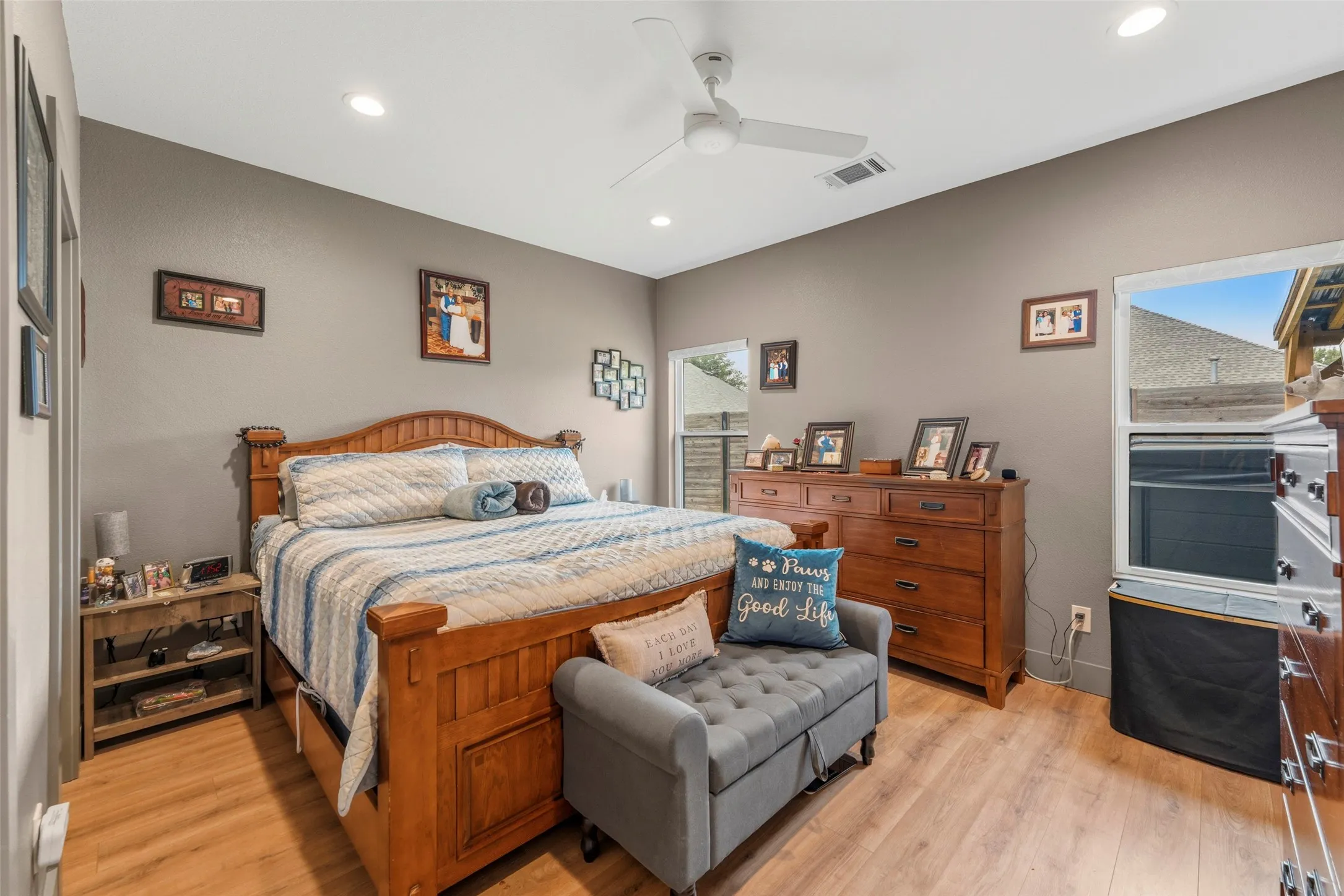 Spacious bedroom featuring wood-finish flooring, recessed lighting, and a ceiling fan