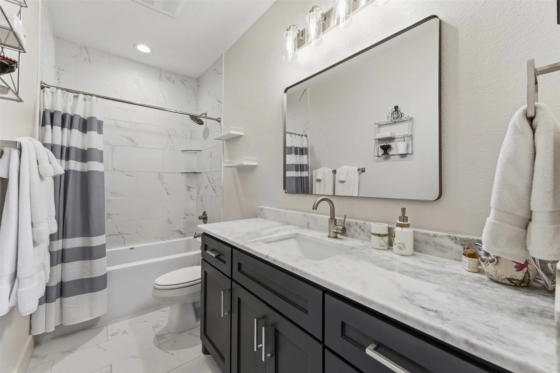 Bathroom featuring a dark wood-finish vanity with a white countertop and integrated sink