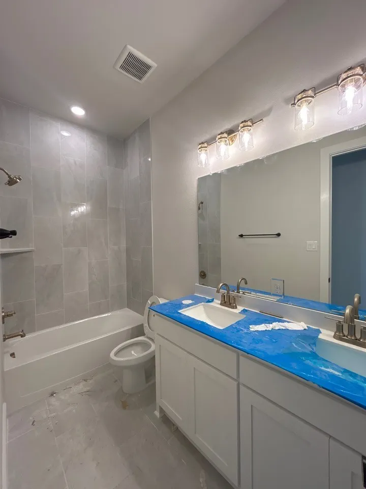 Double vanity with integrated sinks, white cabinetry, and brushed nickel faucets