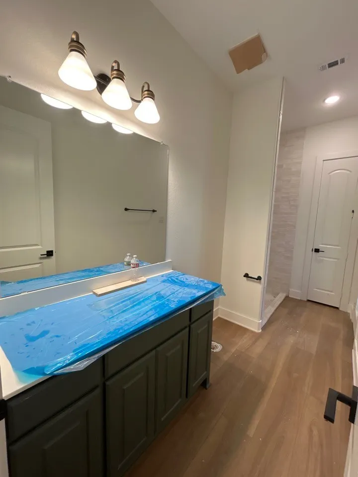 Dark wood-finish vanity with a light-colored countertop