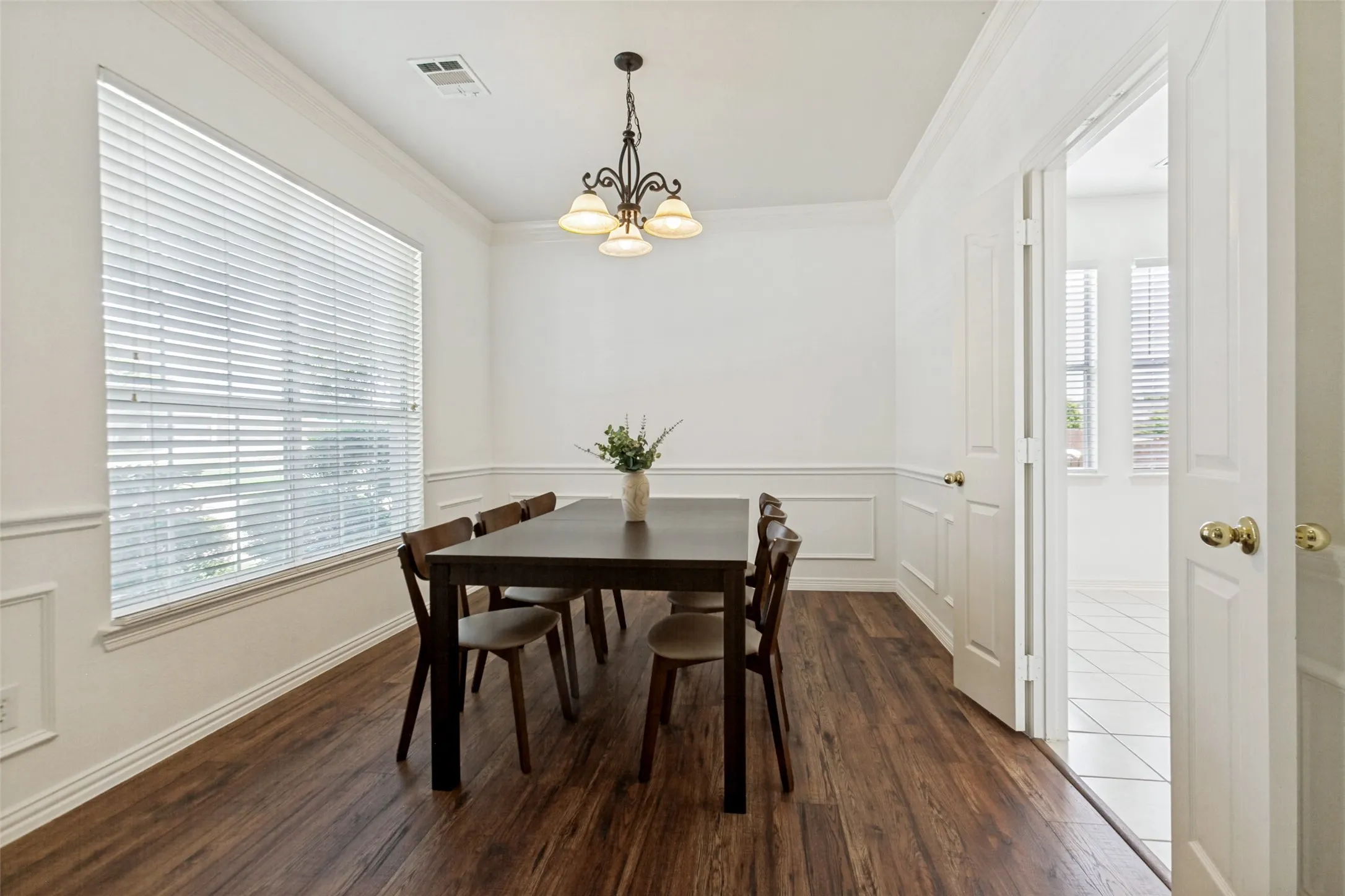 Formal dining room with new LVP flooring and custom wainscoting