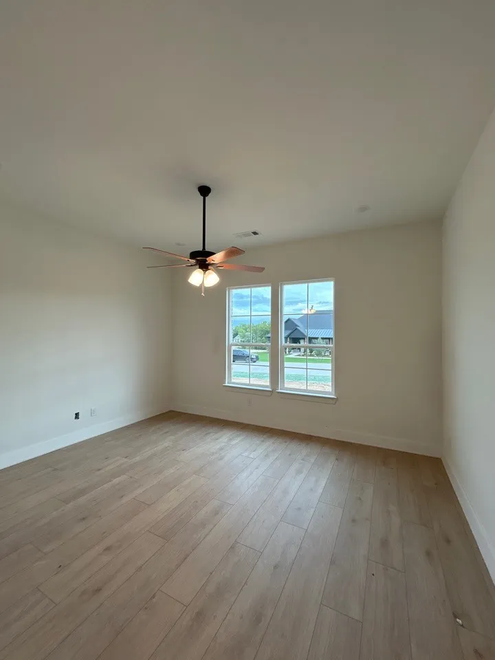 Recessed lighting, wood-finish flooring, and a ceiling fan with integrated lighting