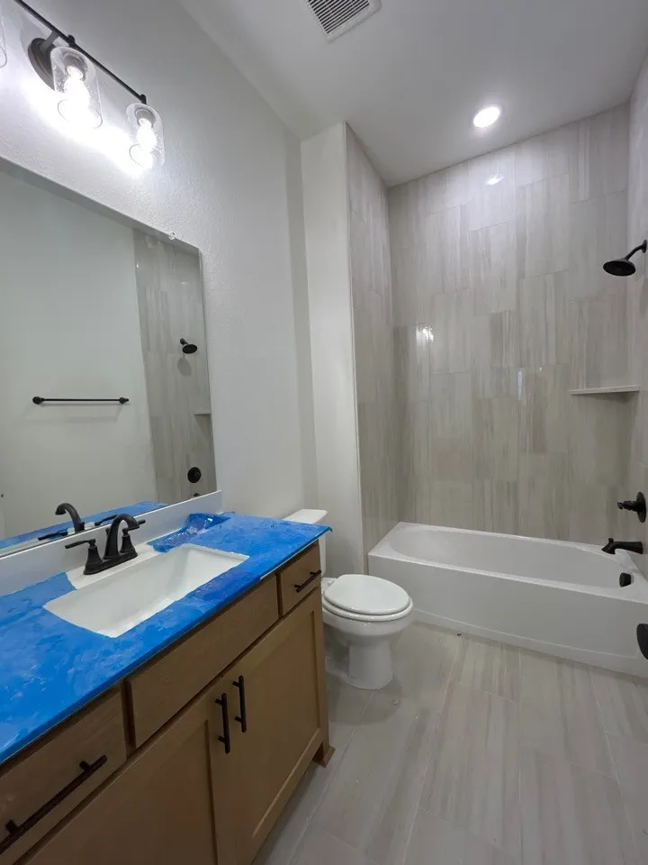 Modern vanity with a rectangular undermount sink and matte black hardware