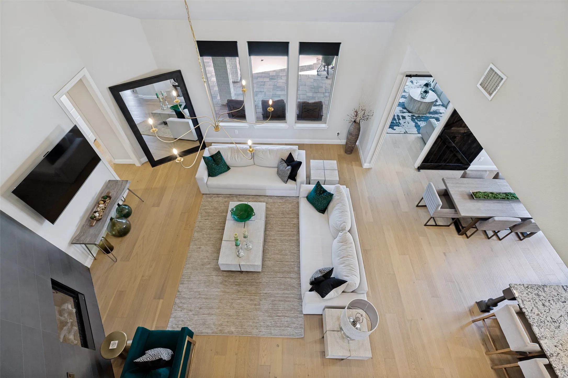 Open-concept living area with soaring ceilings and light wood-finish flooring