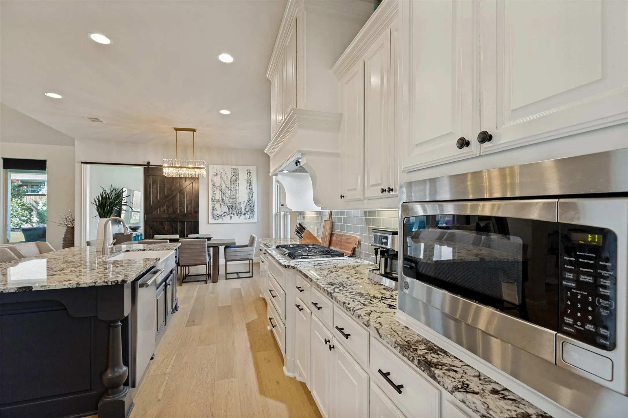 Modern kitchen featuring light wood-finish flooring and recessed lighting