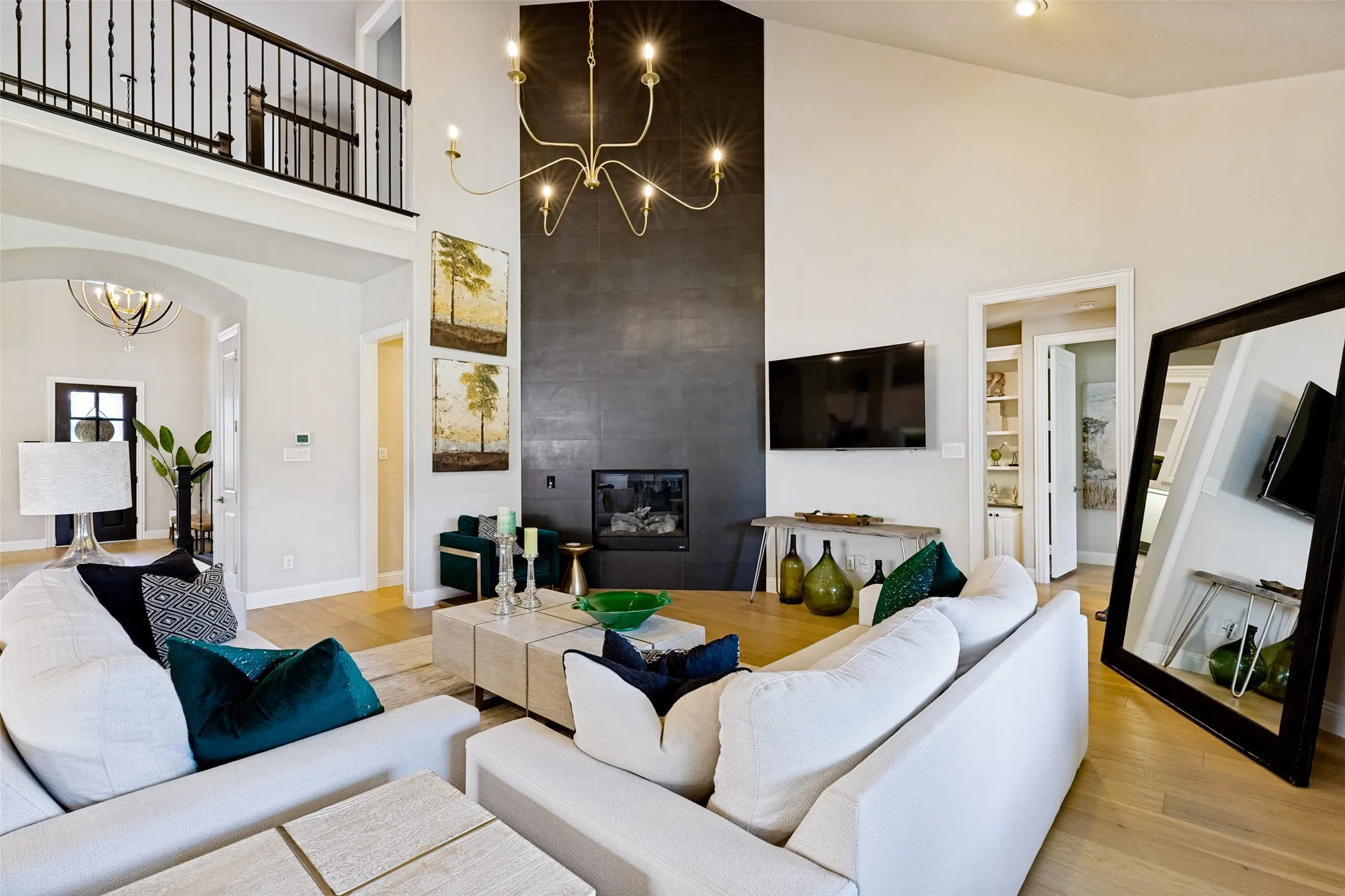 Two-story living area featuring a vaulted ceiling and light wood-finish flooring