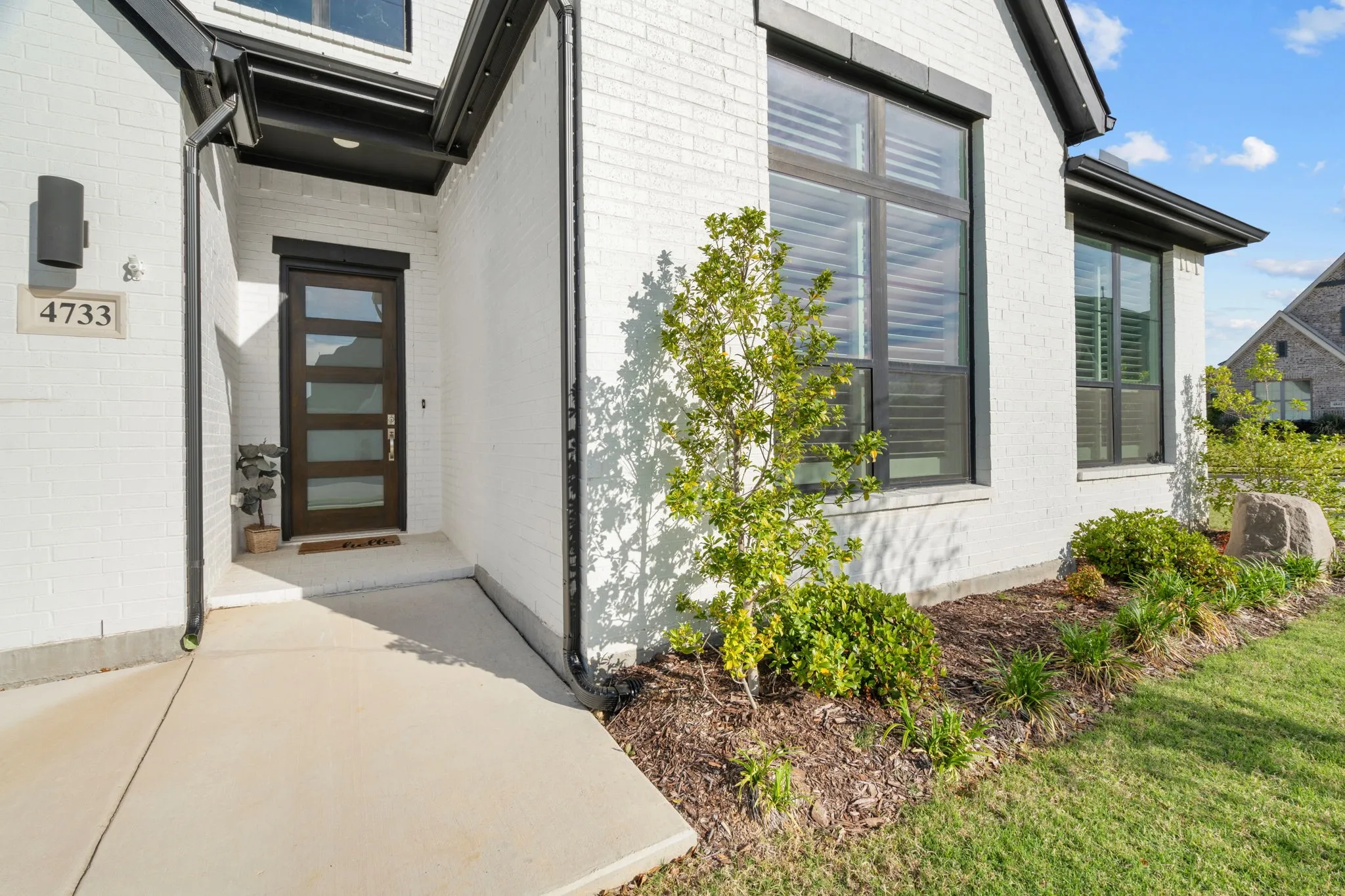 Modern white brick exterior with black trim windows