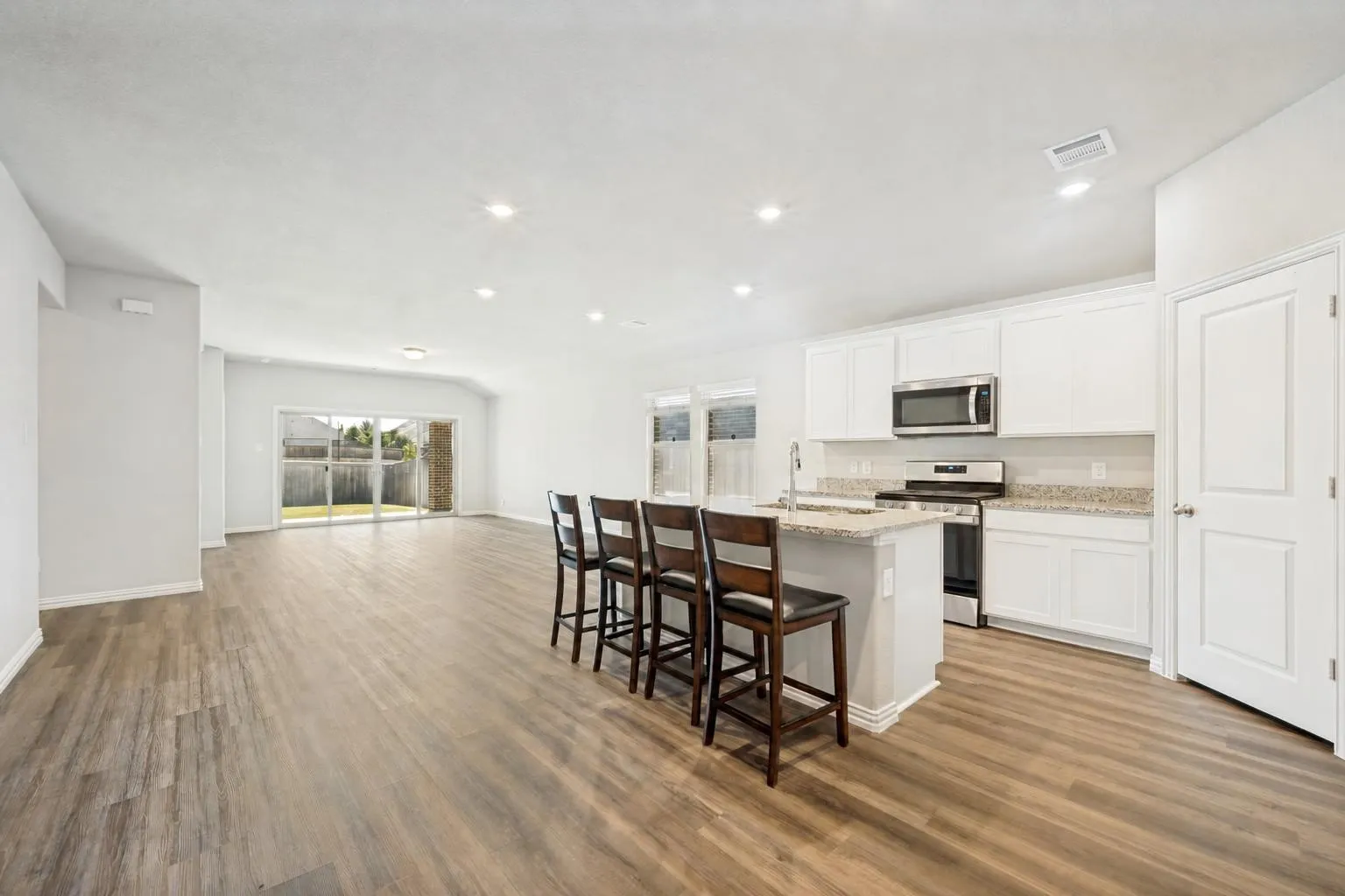 Multiple seating areas in the open concept kitchen, dining, living rooms