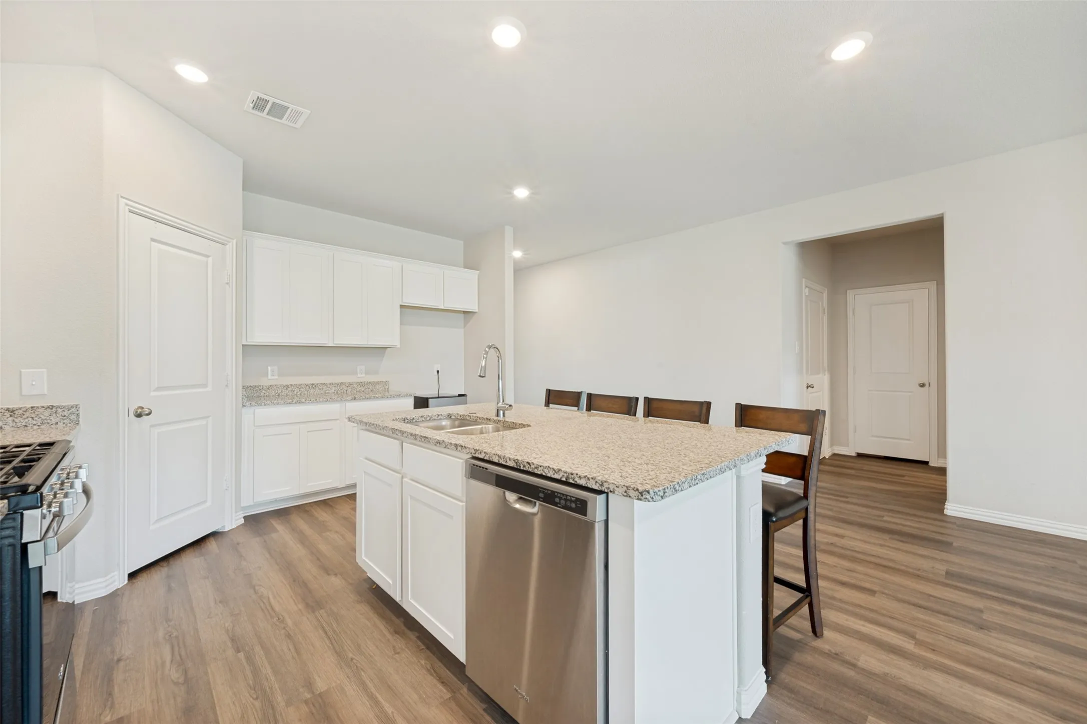 Gas stove, dedicated pantry and kitchen seating.