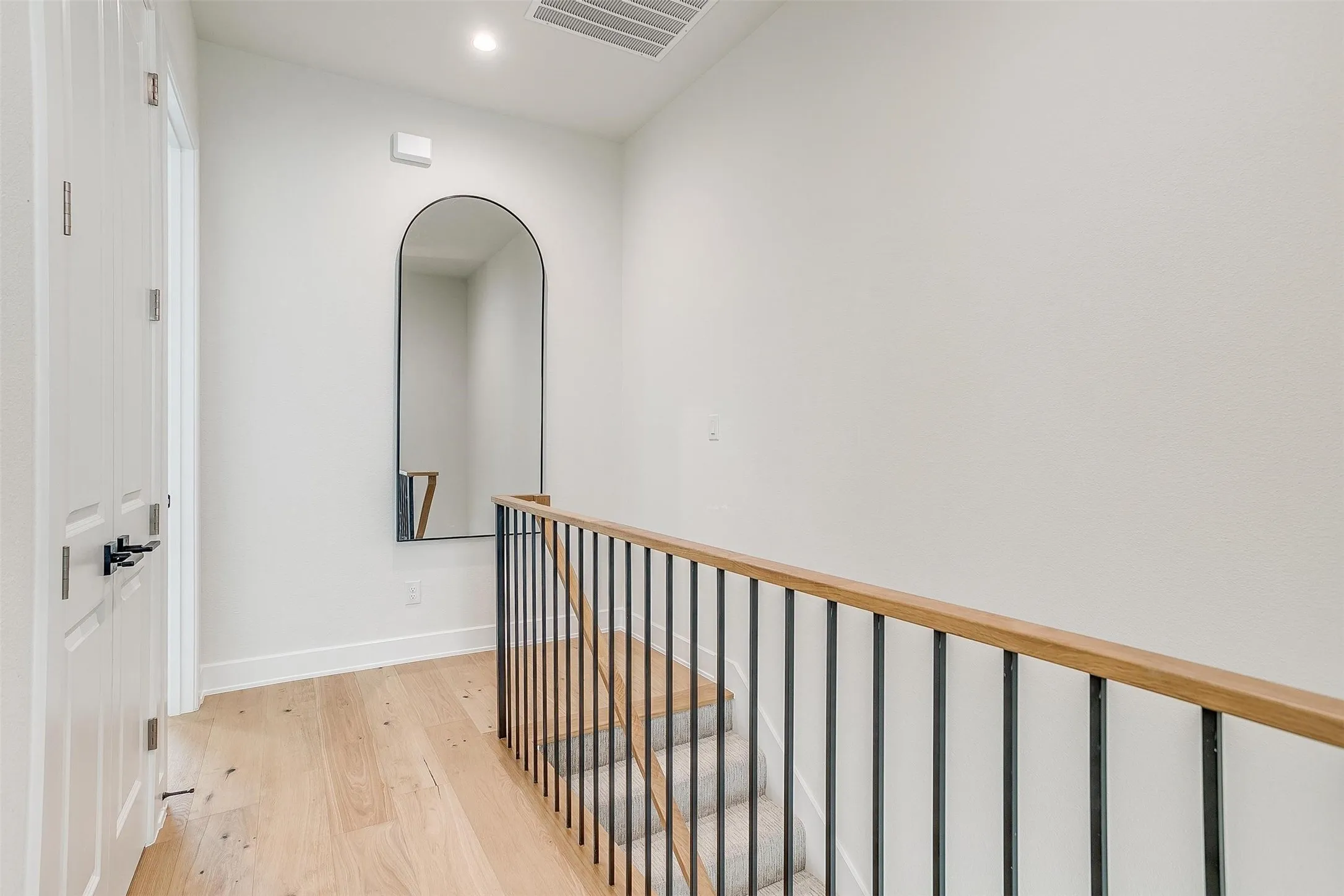 Hall featuring light wood-type flooring and recessed lighting