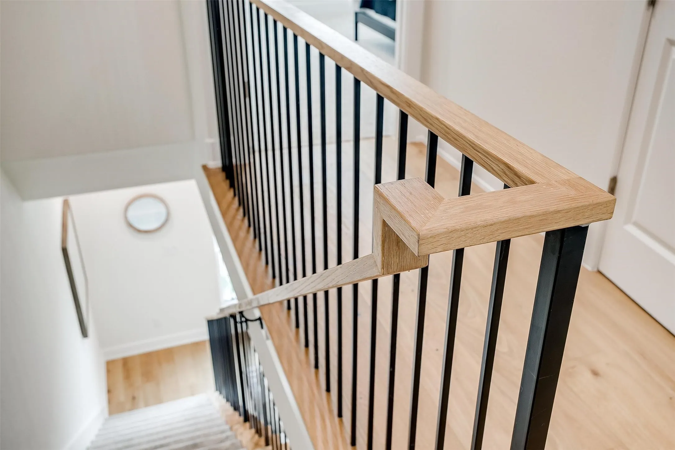 Staircase with wood finished floors and baseboards