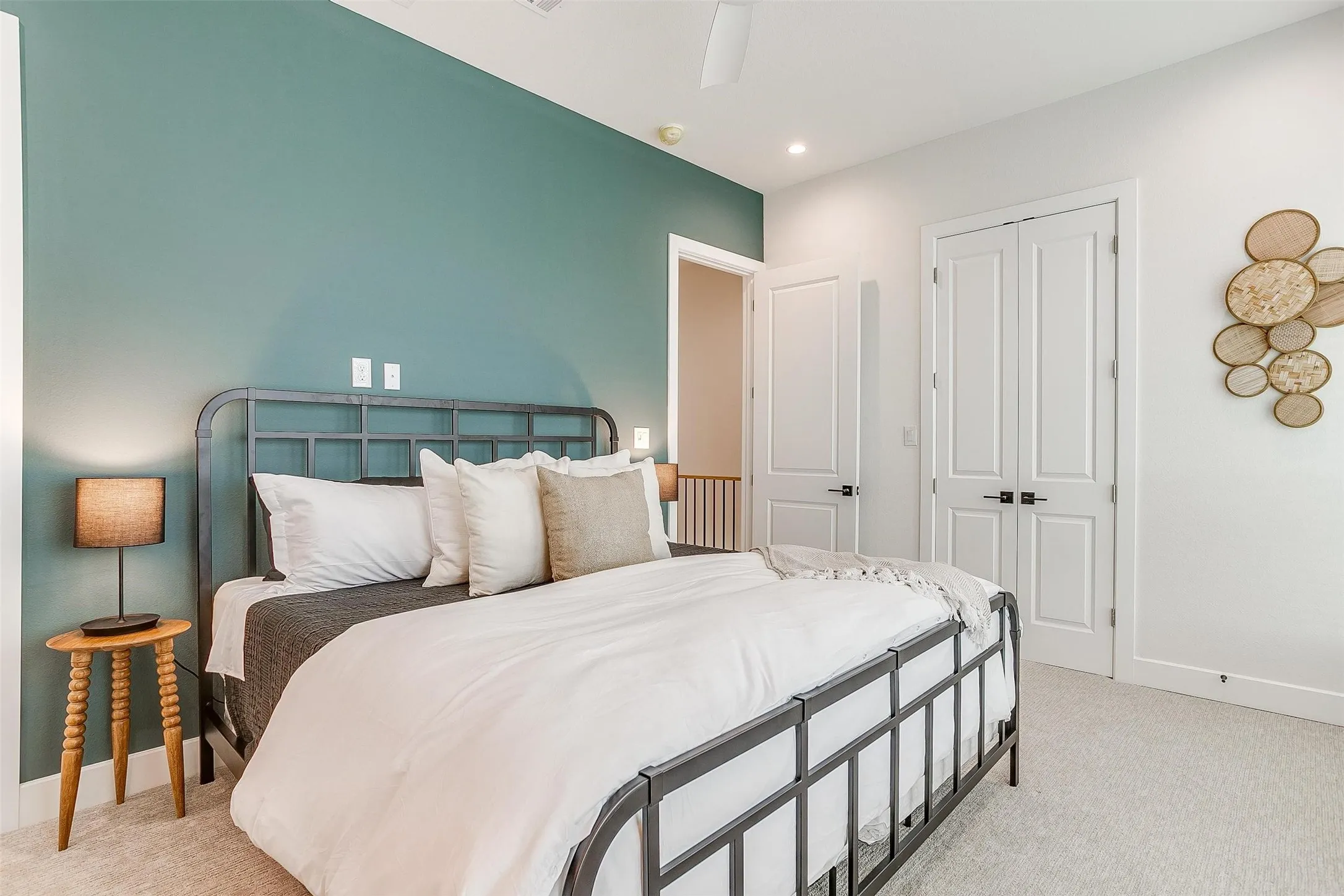 Bedroom with light colored carpet, a closet, ceiling fan, and recessed lighting