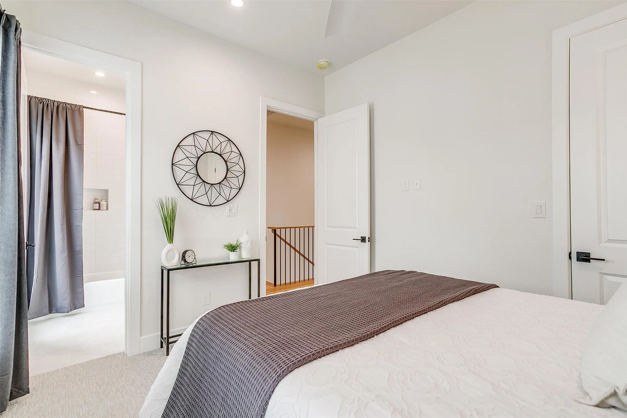 Bedroom with light carpet, recessed lighting, and ensuite bathroom