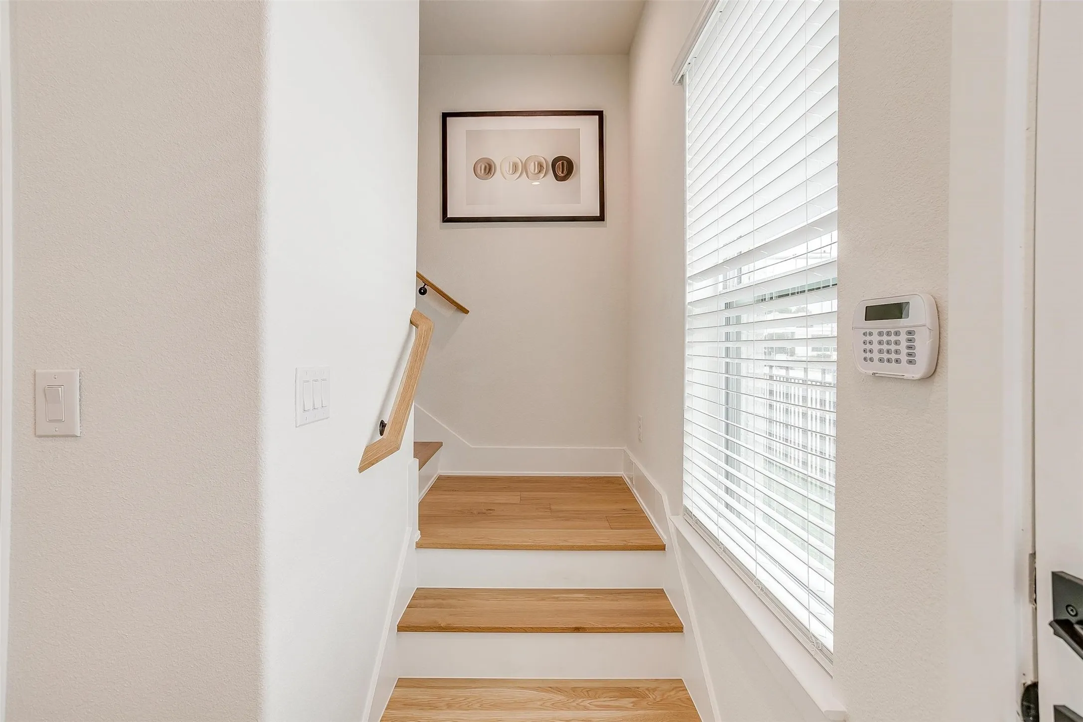 Staircase with wood finished floors and baseboards