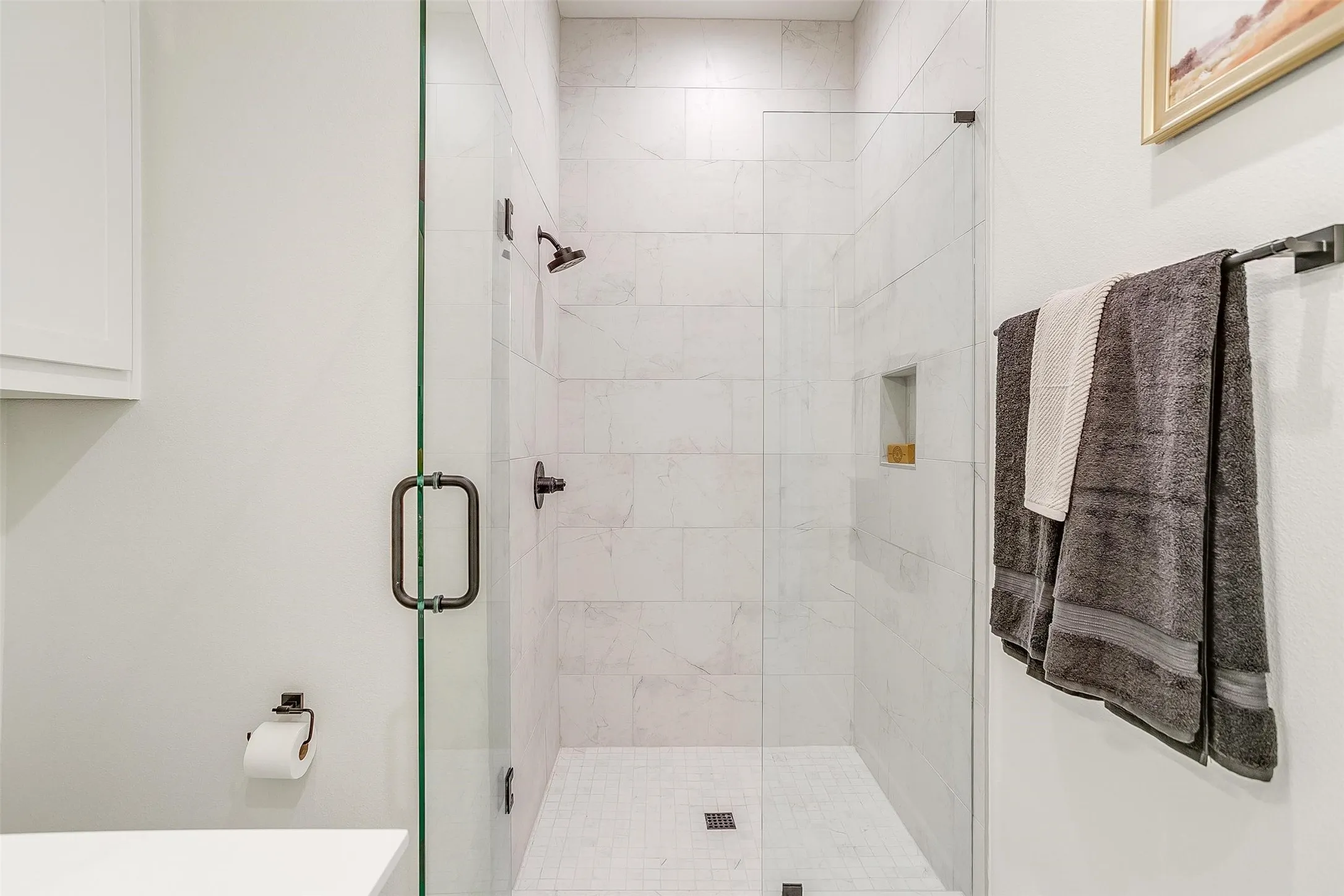 Bathroom featuring a marble finish shower