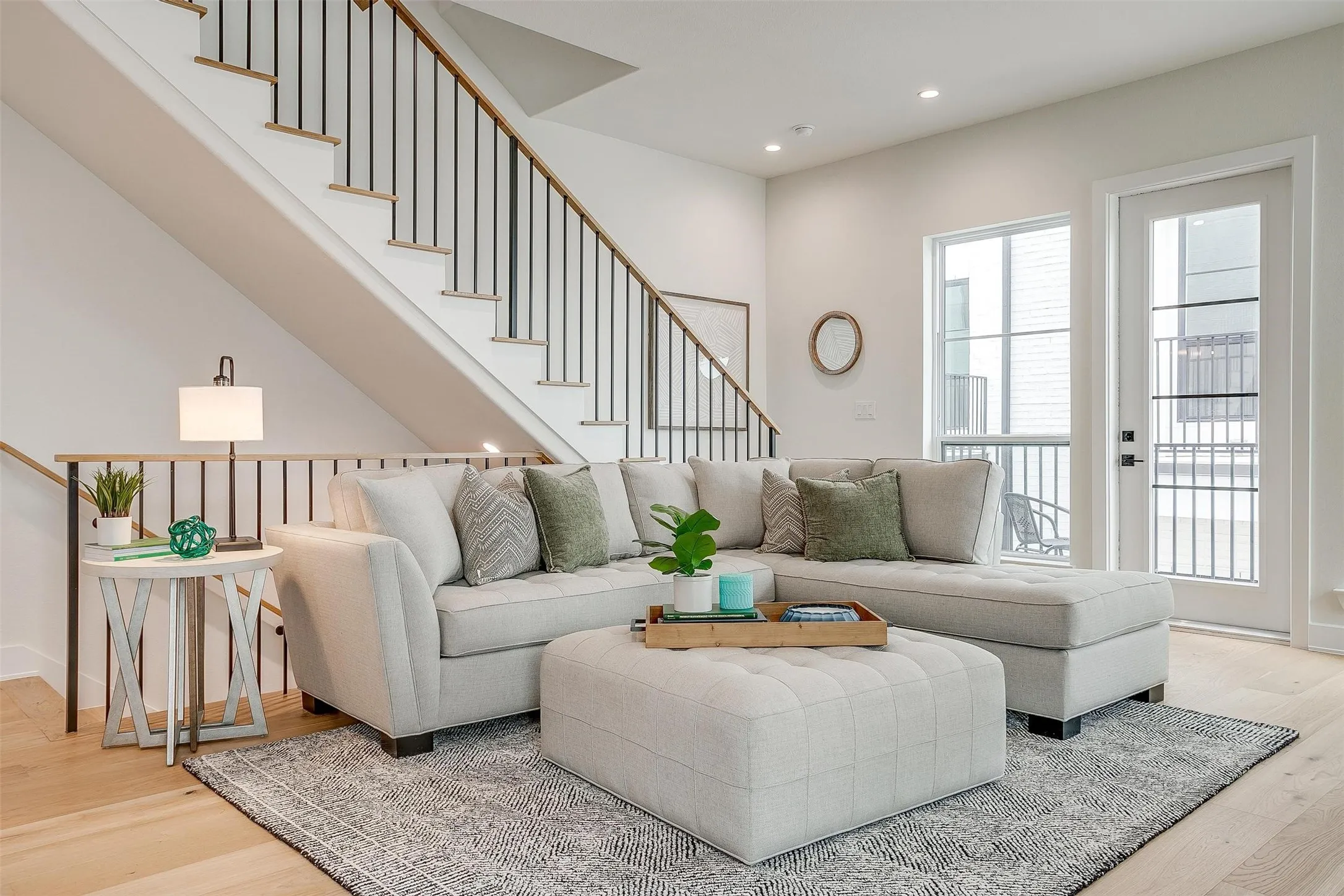 Living area featuring light wood-type flooring, recessed lighting, and stairway