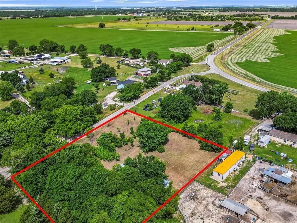 Expansive lot featuring a mix of mature trees and open land