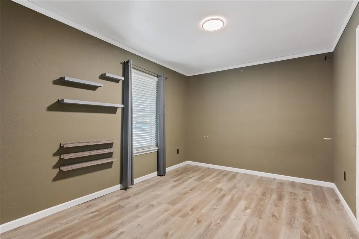 Light wood-finish flooring with crisp white baseboards