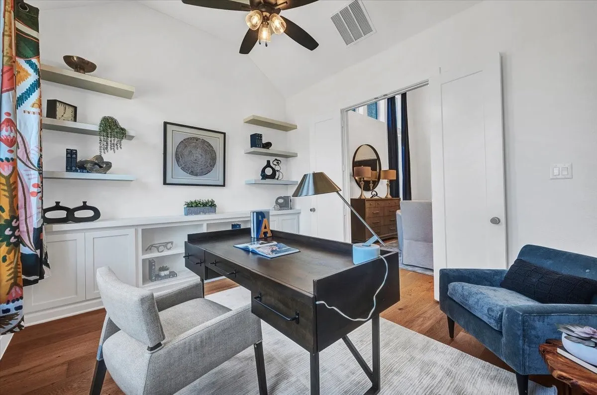 Vaulted ceiling featuring a ceiling fan, recessed lighting, built-in cabinetry with open shelving, wood-finish flooring, and a sliding door