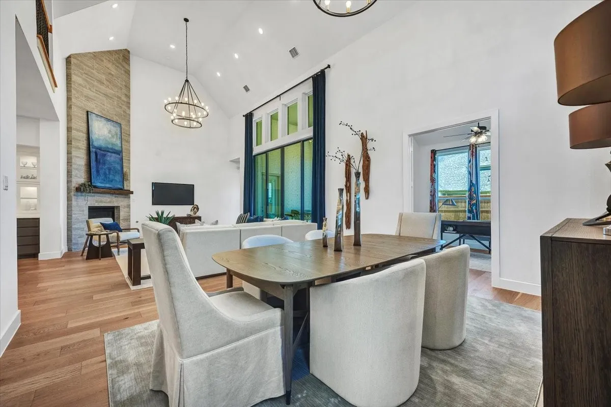 Open-concept living area featuring a vaulted ceiling and wood-finish flooring