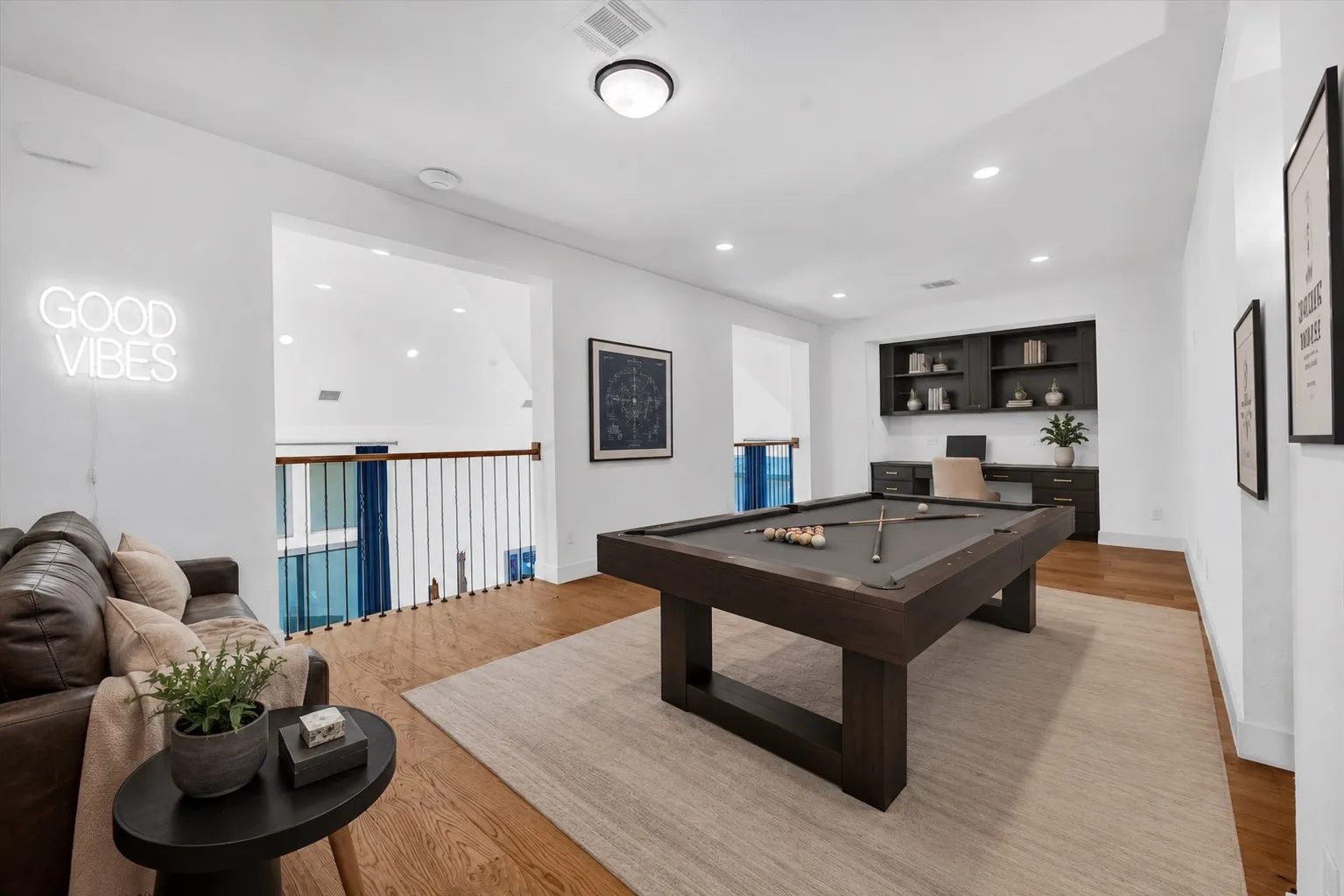 Virtually staged - Bright loft space featuring wood-finish flooring and recessed lighting