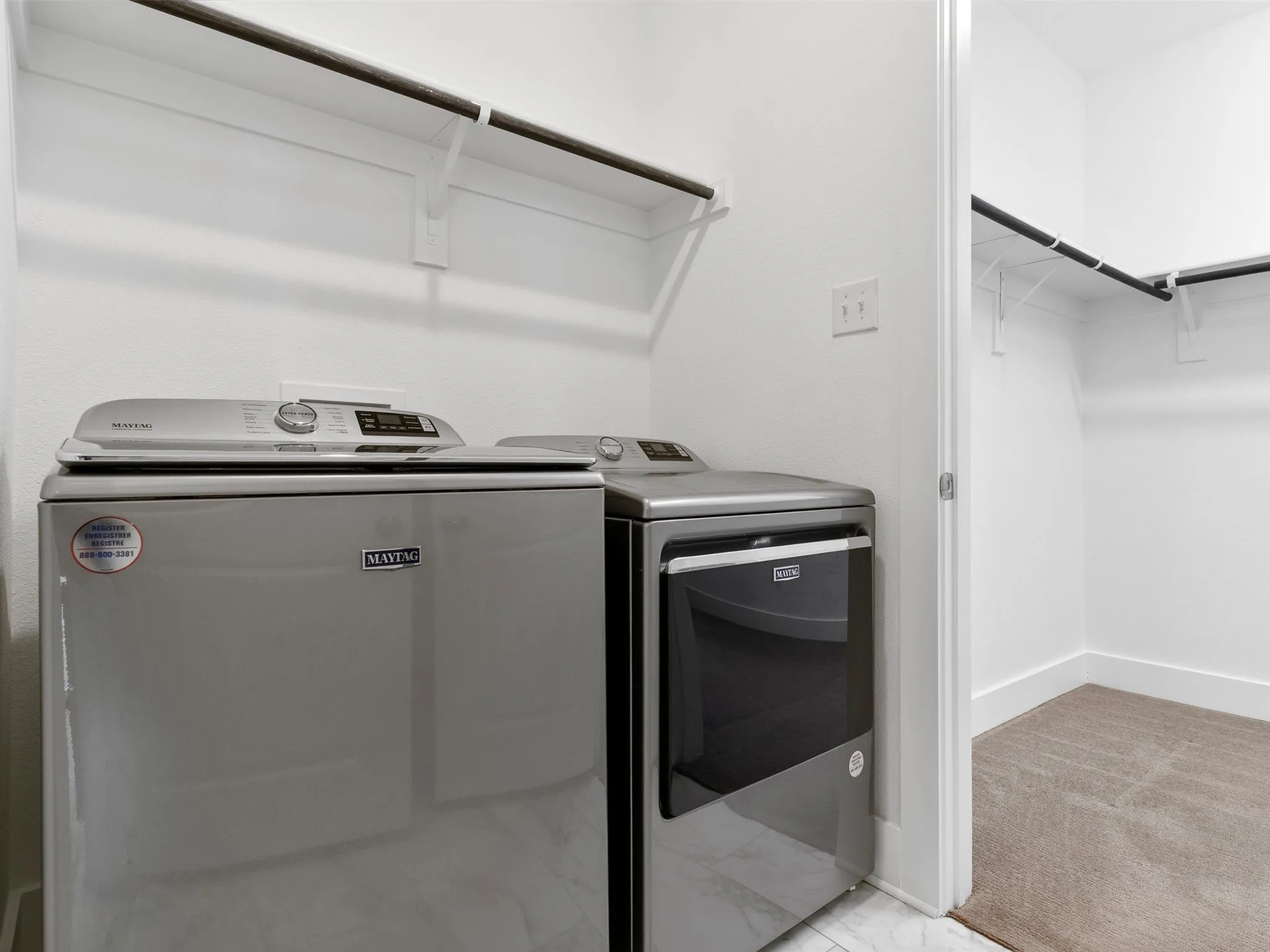 Laundry room with Maytag Appliances- conveniently located off primary closet.