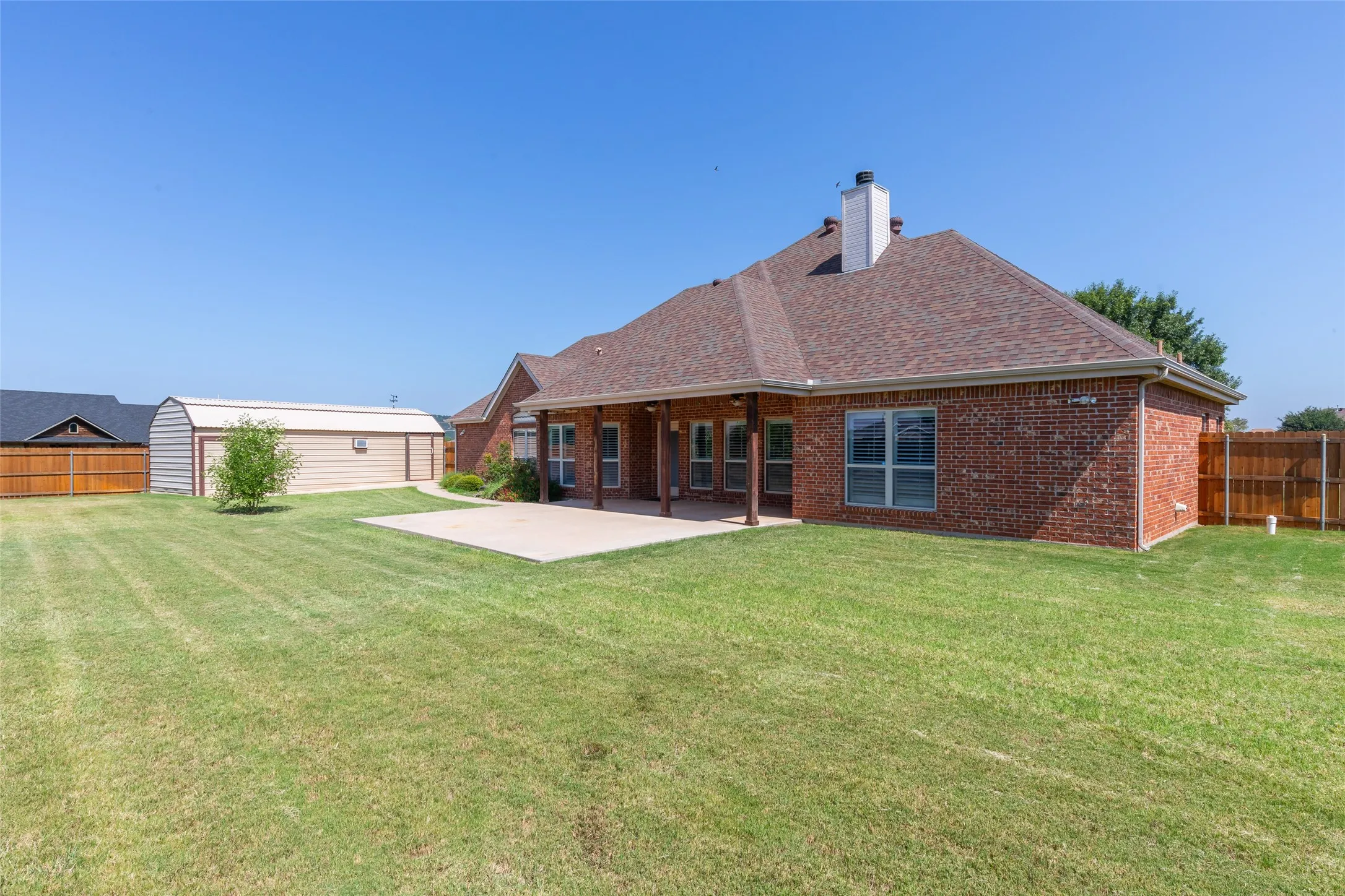 Large covered patio, large 24 x 14 shop and small attached storage unit (8 x 14).  Backyard is fully enclosed with privacy fence