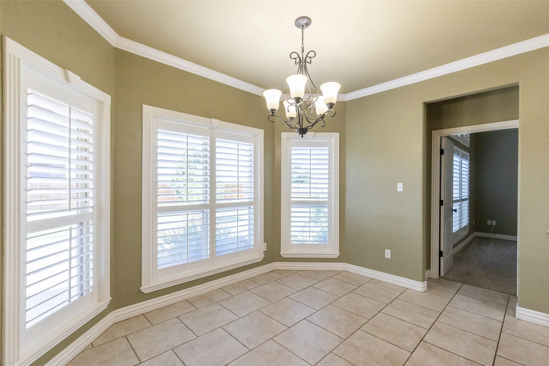 Sizable breakfast area with a view into the backyard and the Primary Bedroom