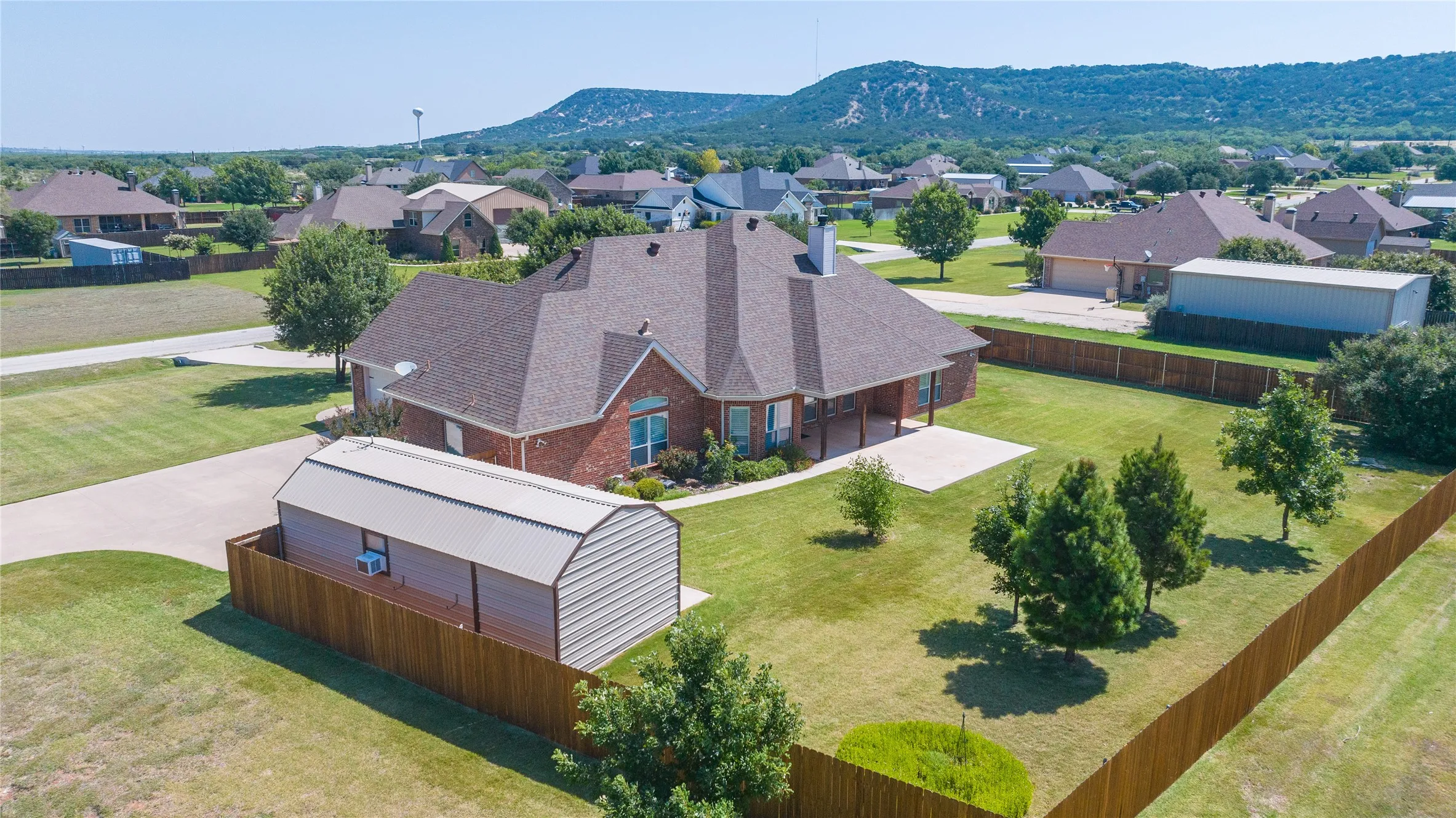 The backyard includes a large shop approximately 24 x 14 with a separate storage unit attached.
The large shop has electricity and a/c window units