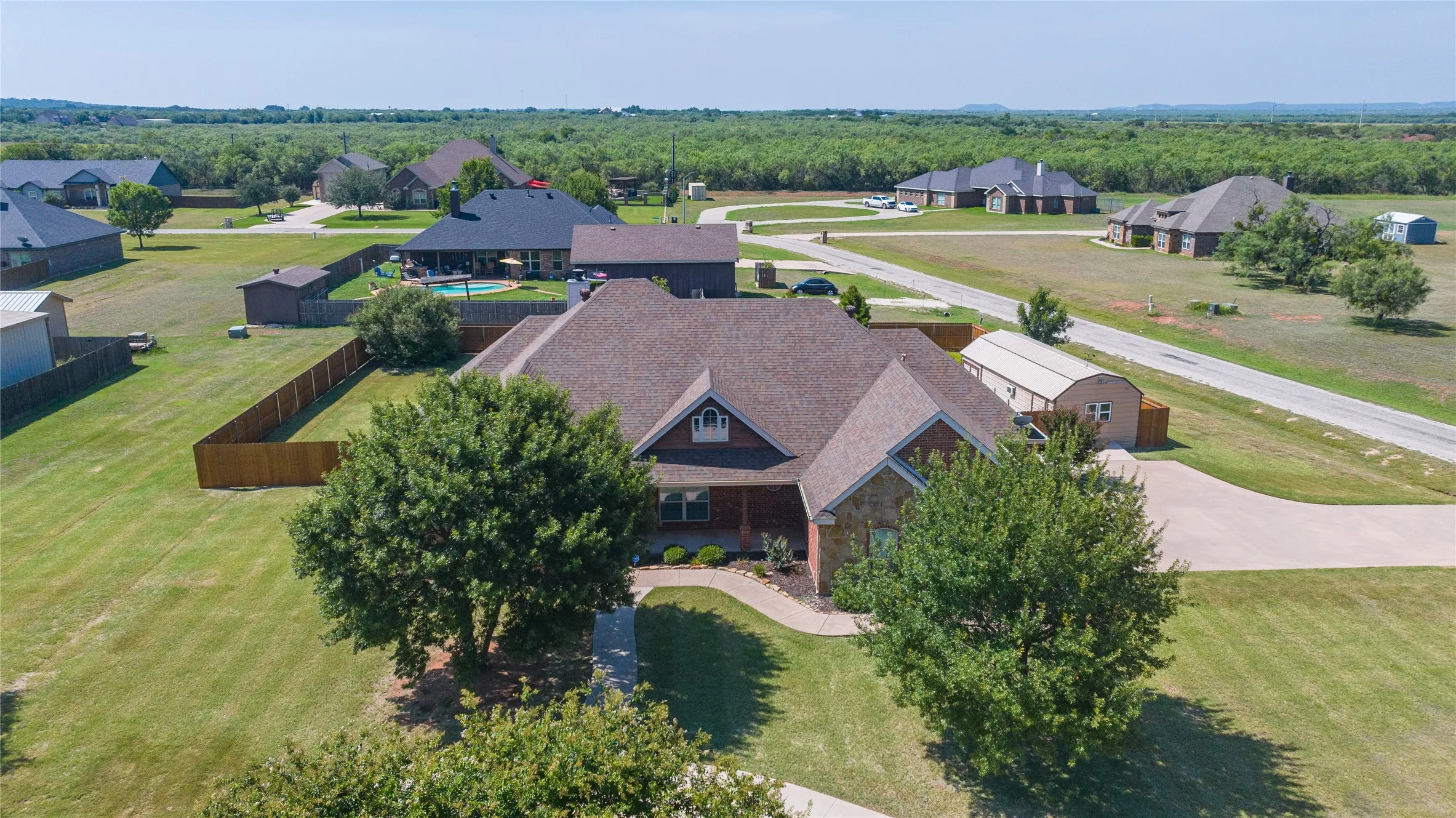 Front of home with beautiful mountain views, side entrance driveway and large circular front driveway.