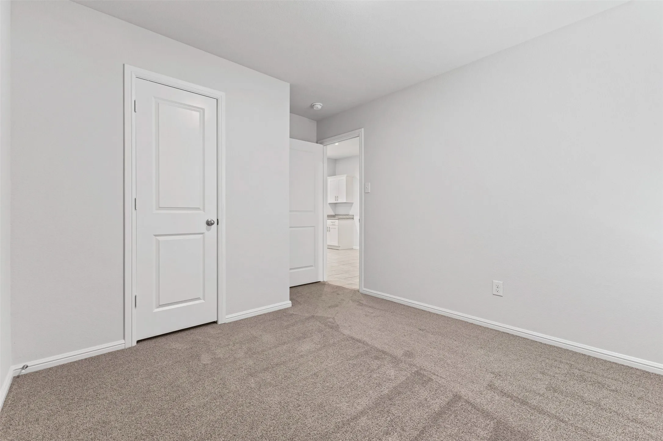 Neutral-toned carpeting paired with light wall finishes