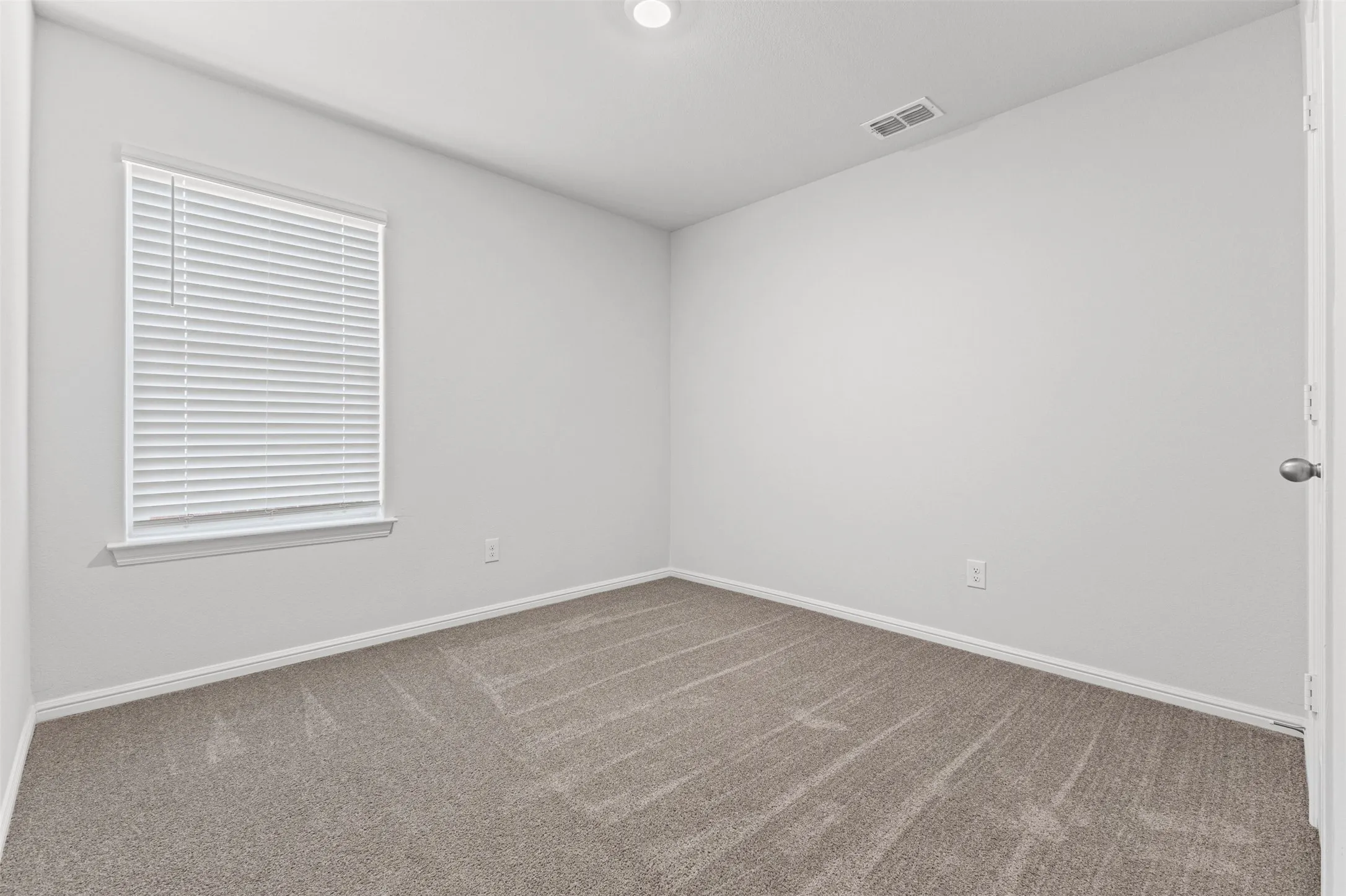 Neutral-toned wall paint and textured carpeting
